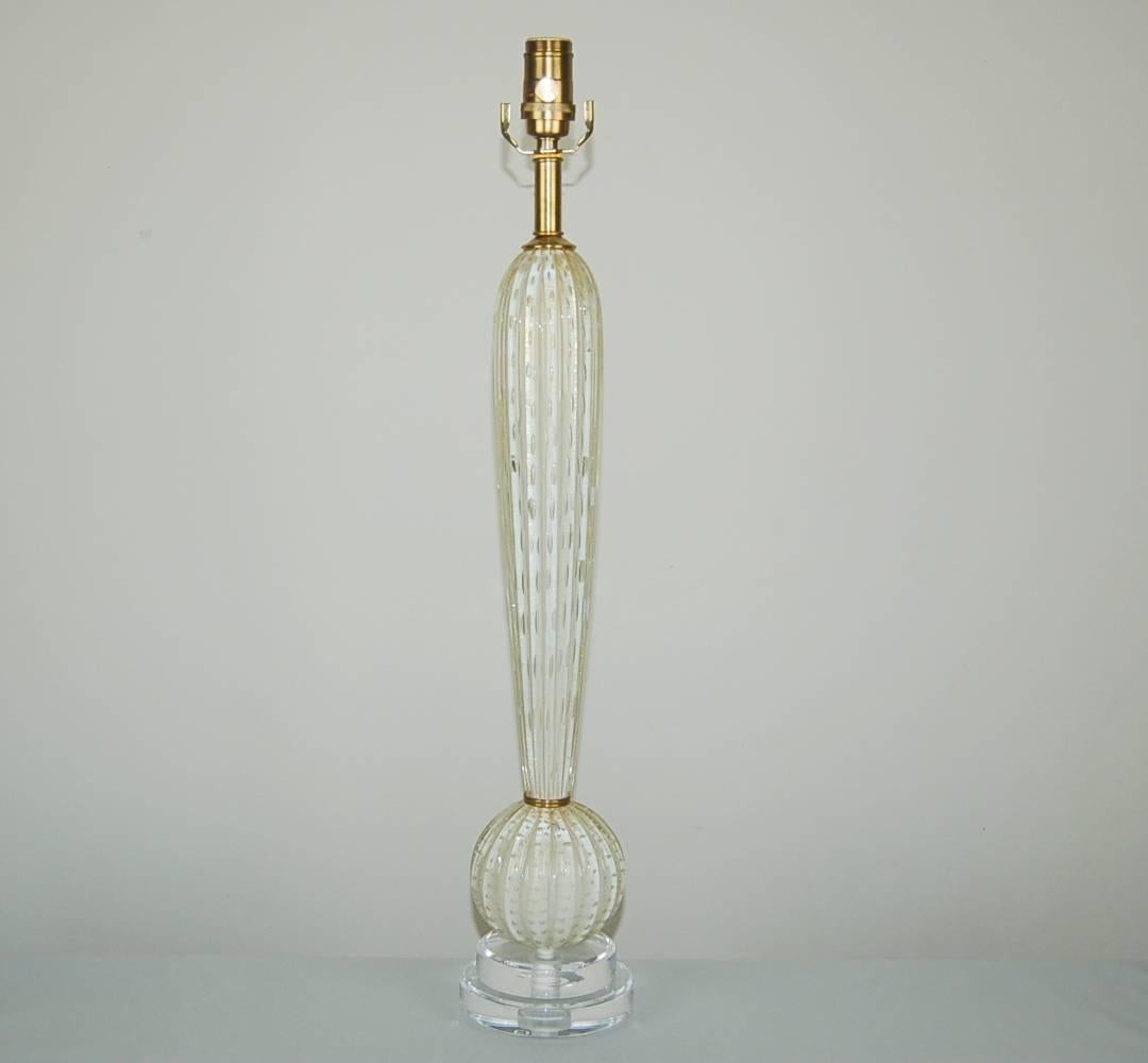 Vintage Murano table lamp of an inverted WHITE teardrop atop a globe, with brass at the waist. Each piece is filled with controlled bubbles and GOLD inclusion. 

The lamp stands 28 inches from tabletop to socket top. As shown, the top of shade is 33