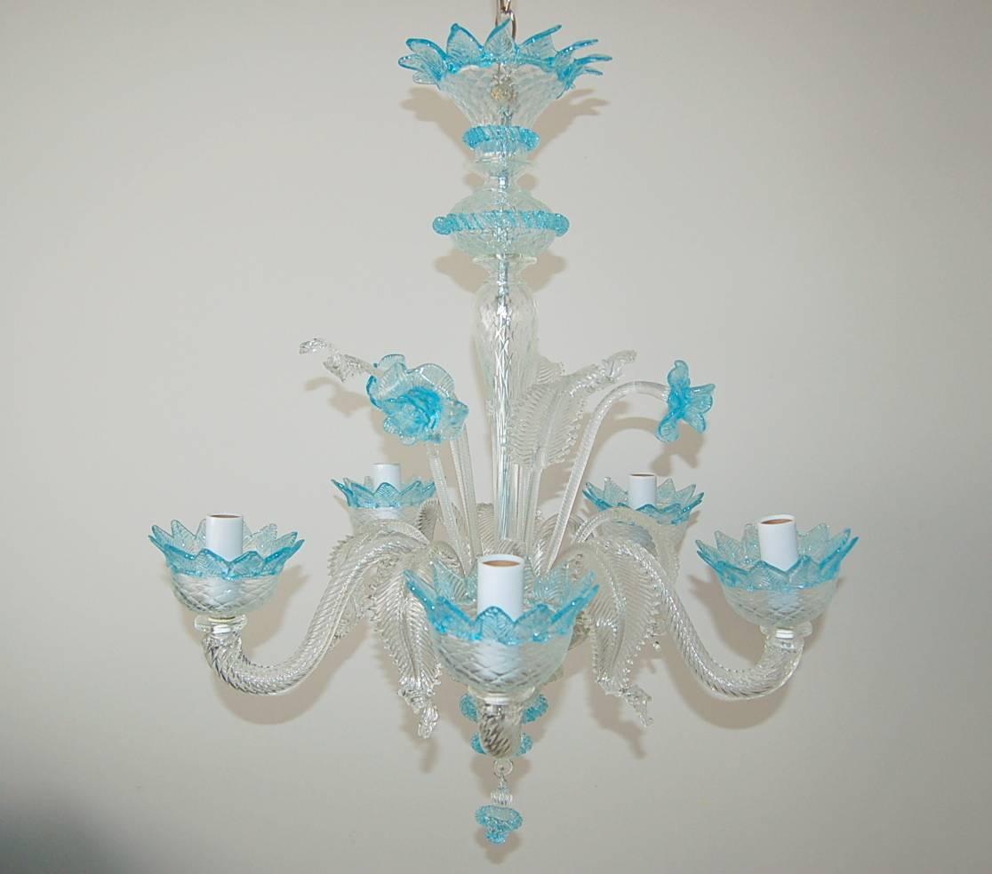 Very chic vintage five-light Murano glass chandelier, circa 1950s, made of Murano crystal with blue glass accents. Newly rewired and rebuilt. 

The chandelier is 25 inches in width and 29 inches in height, from glass to glass.