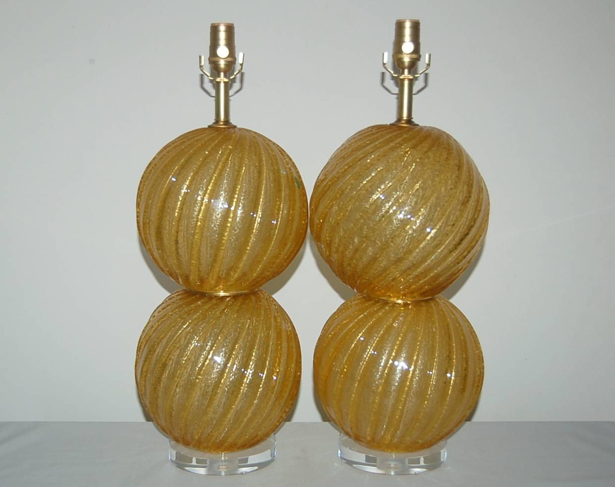 Eye popping stacked ball lamps in HARVEST GOLD! Wonderful Pulegoso glass with tons of tiny bubbles inside gives the illusion of a frosty treat. 

The lamps measure 23 inches from tabletop to socket top. As shown, the top of shade is 30 inches high.