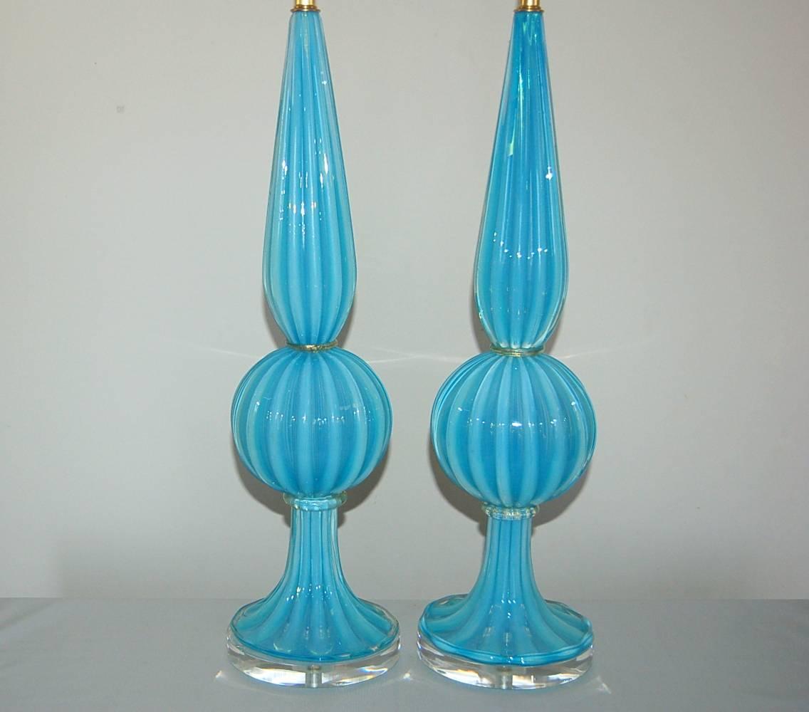 Such a tall and elegant matched pair of vintage Murano table lamps in glorious Opaline OCEAN BLUE. No chips, no flaws, totally rewired as new. Simply spectacular!

They stand 30 inches from tabletop to socket top. As shown, the top of shade is 37