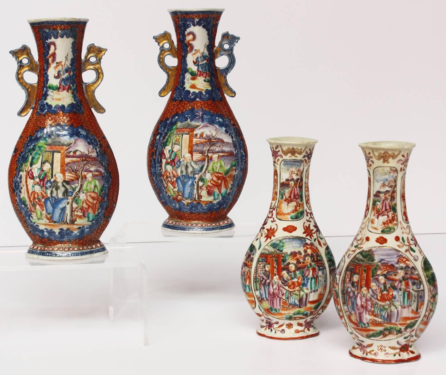 On left:
Pair of early 18th century mandarin pallet Chinese vases decorated with various scenes and gilt handles (on neck), orange ground with blue borders around scenes.

Measures: 11.5