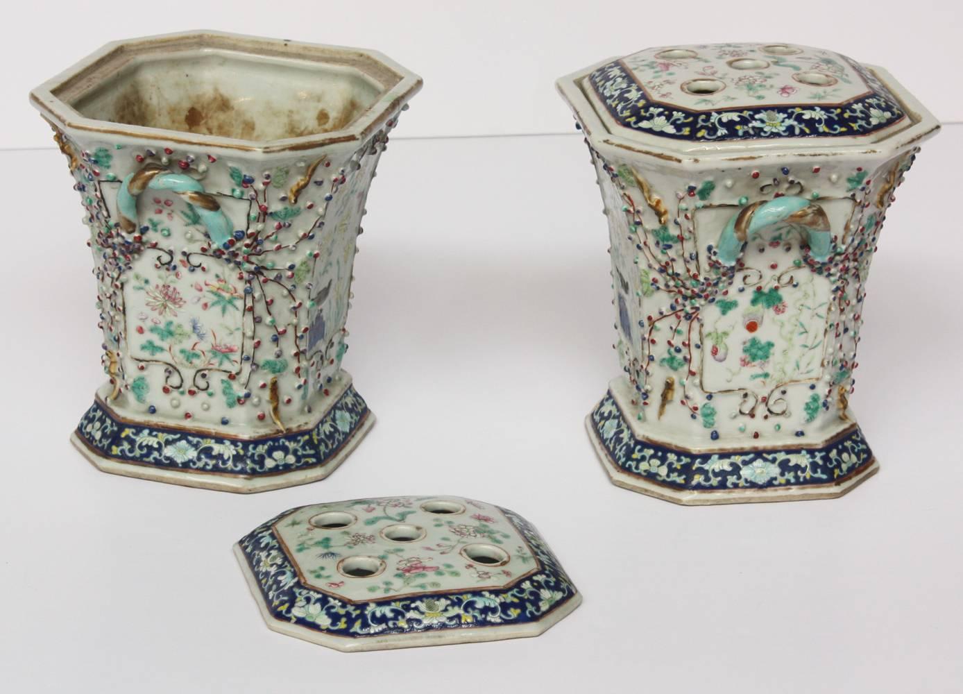 Pair of Chinese export bough pots with original lids, famille rose panels decorated with birds and squirrels.