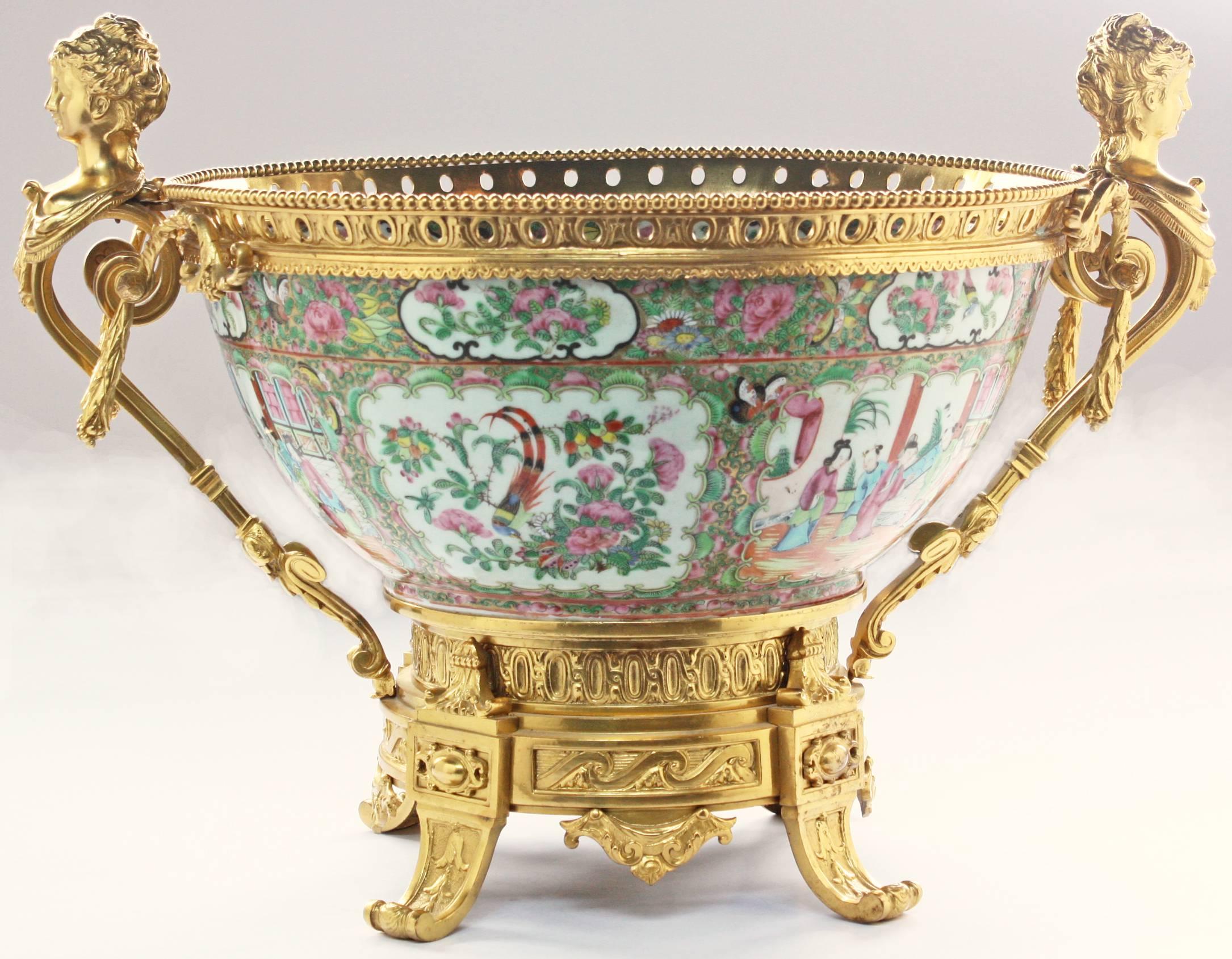 A large 19th century Chinese rose medallion bowl on footed gilt base with beaded band around rim with bust of ladies on each side.
