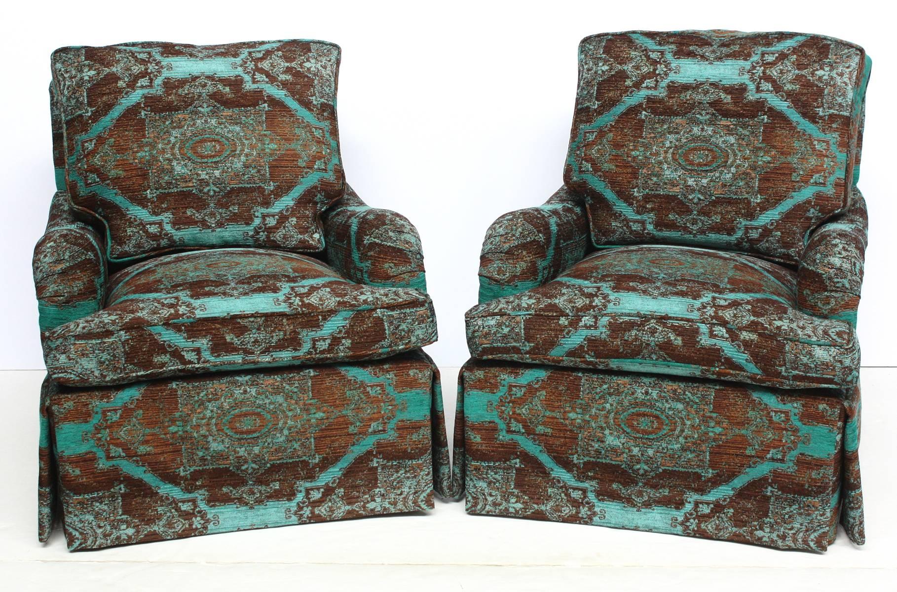A beautiful pair of English saddle arm club chairs covered in newly upholstered textural turquoise and brown fabric. circa 1930