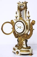 Reloj francés en forma de lira de mármol y bronce dorado, estilo Luis XVI
