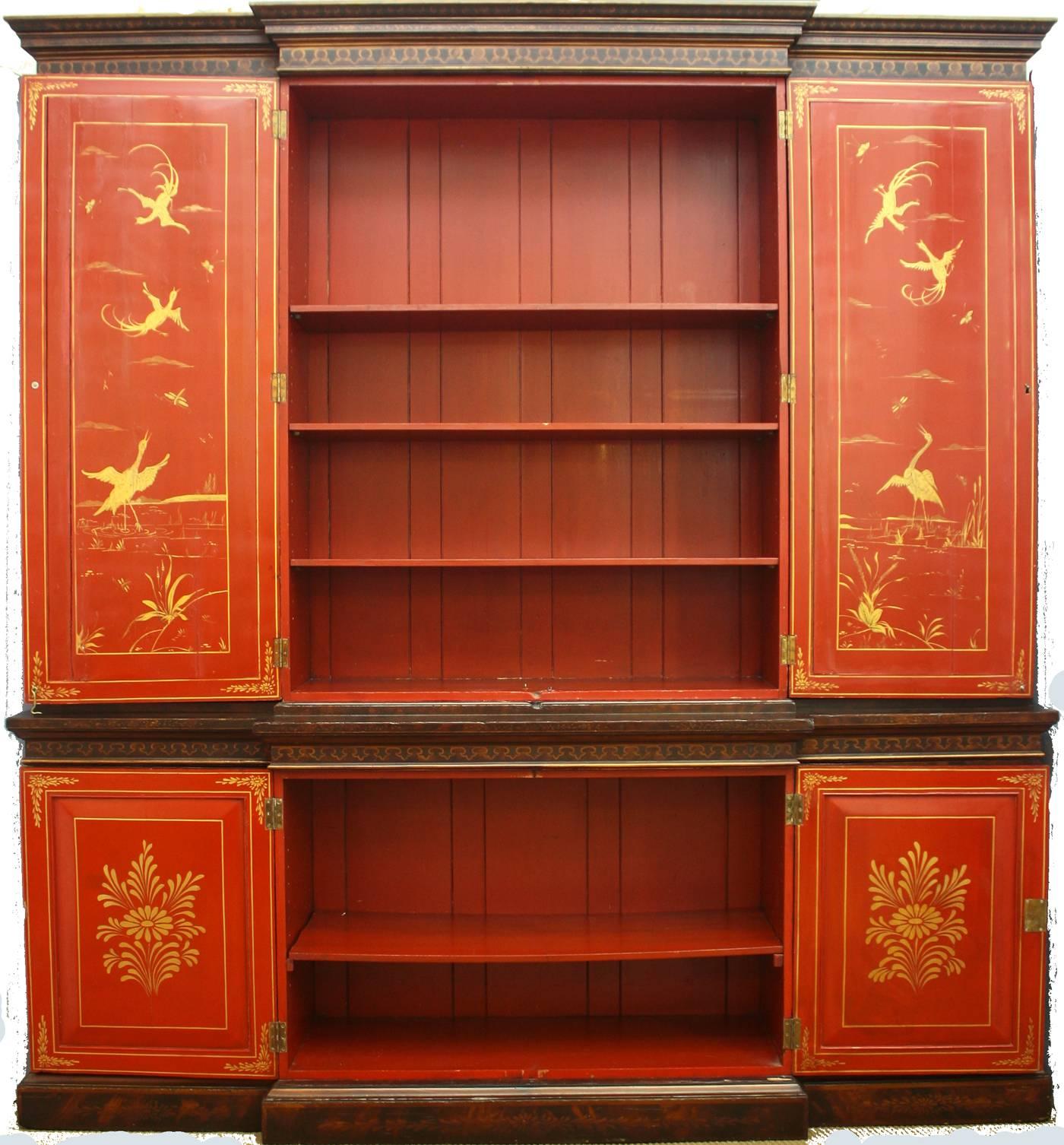 A George III breakfront bookcase with later Japanned chinoiserie decoration, a molded cornice above two central paneled doors, flanked on each side by like doors, cinnabar colored interior with more decoration on the backside of the doors, upper