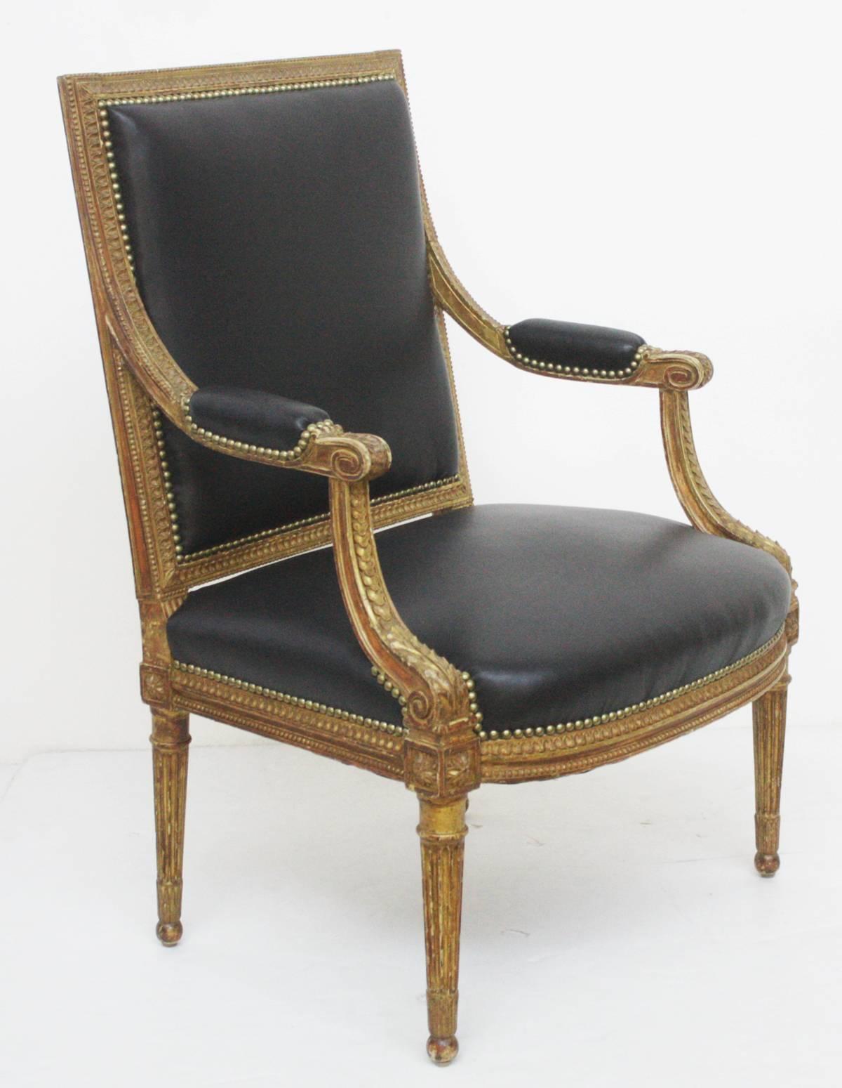 Group of four Louis XVI style giltwood fauteuils or armchairs with new black leather upholstery with nailhead trim

Available as two pairs $6,800.00 per pair.
One pair sold.