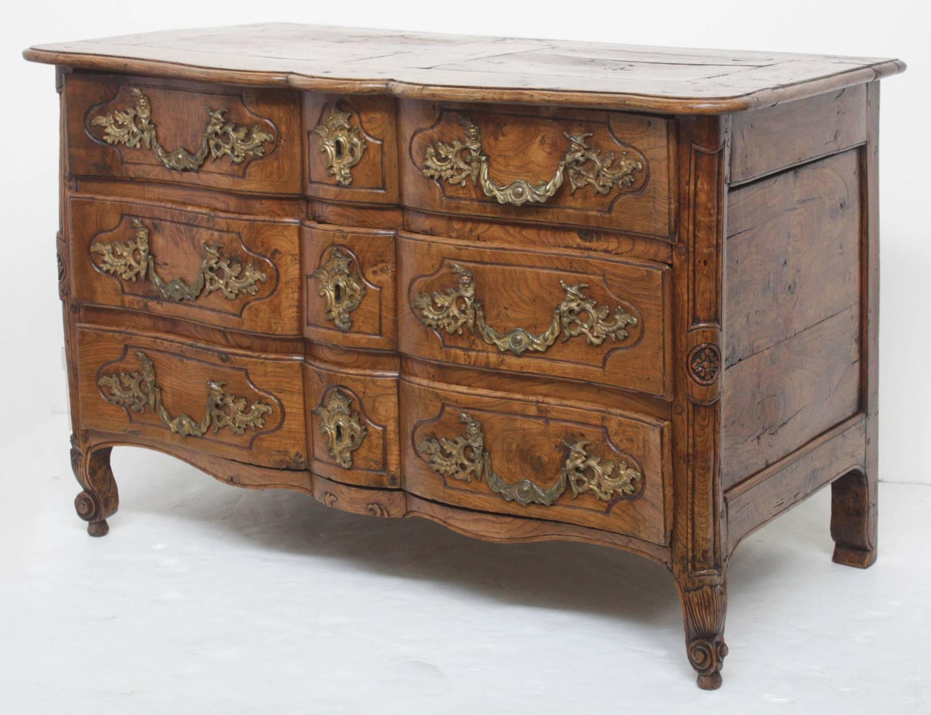 A Louis XV period burled elm ormolu-mounted commode. 