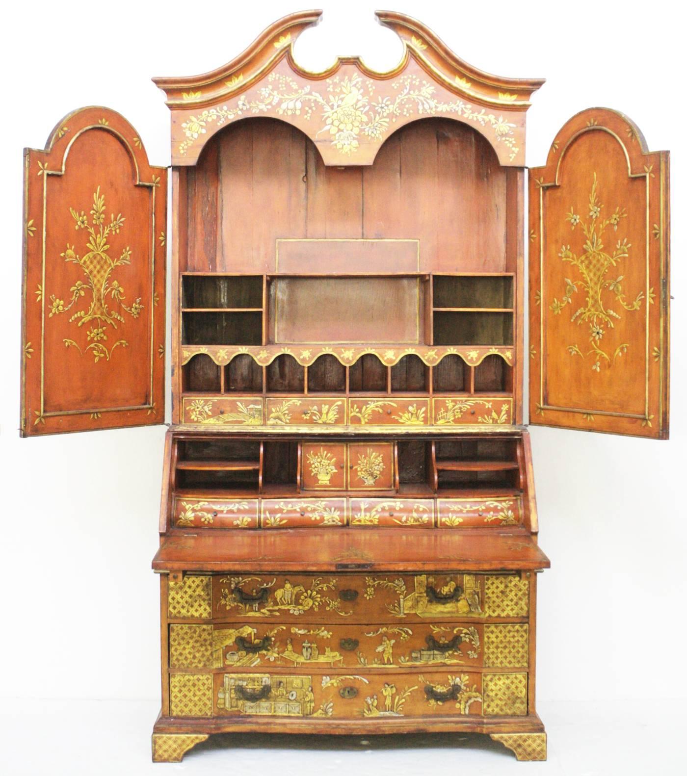 An exquisite orange / red (or red / orange) with gilt chinoiserie pattern design secretary, two doors at top with fitted interior, centre desk portion opens to show cubby holes and shelves, base with four drawers, broken pediment at top

with two