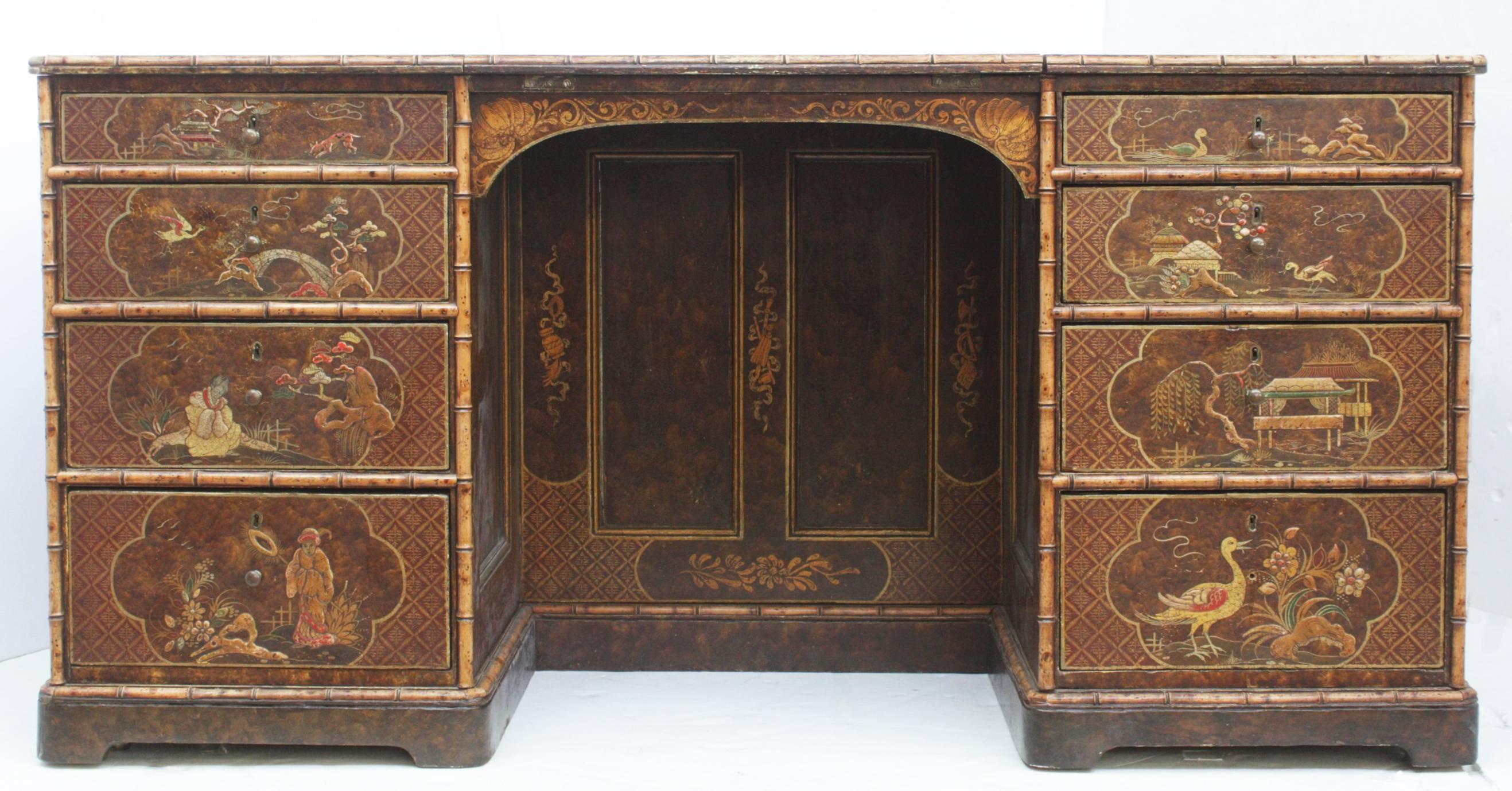 A large desk/library table, painted and gilded chinoiserie design with faux bamboo trim, embossed leather surface with slant (adjustable) writing board (Image 9), drawers both front and back, adjustable shelves front of desk (Image 4)

the Chubb's