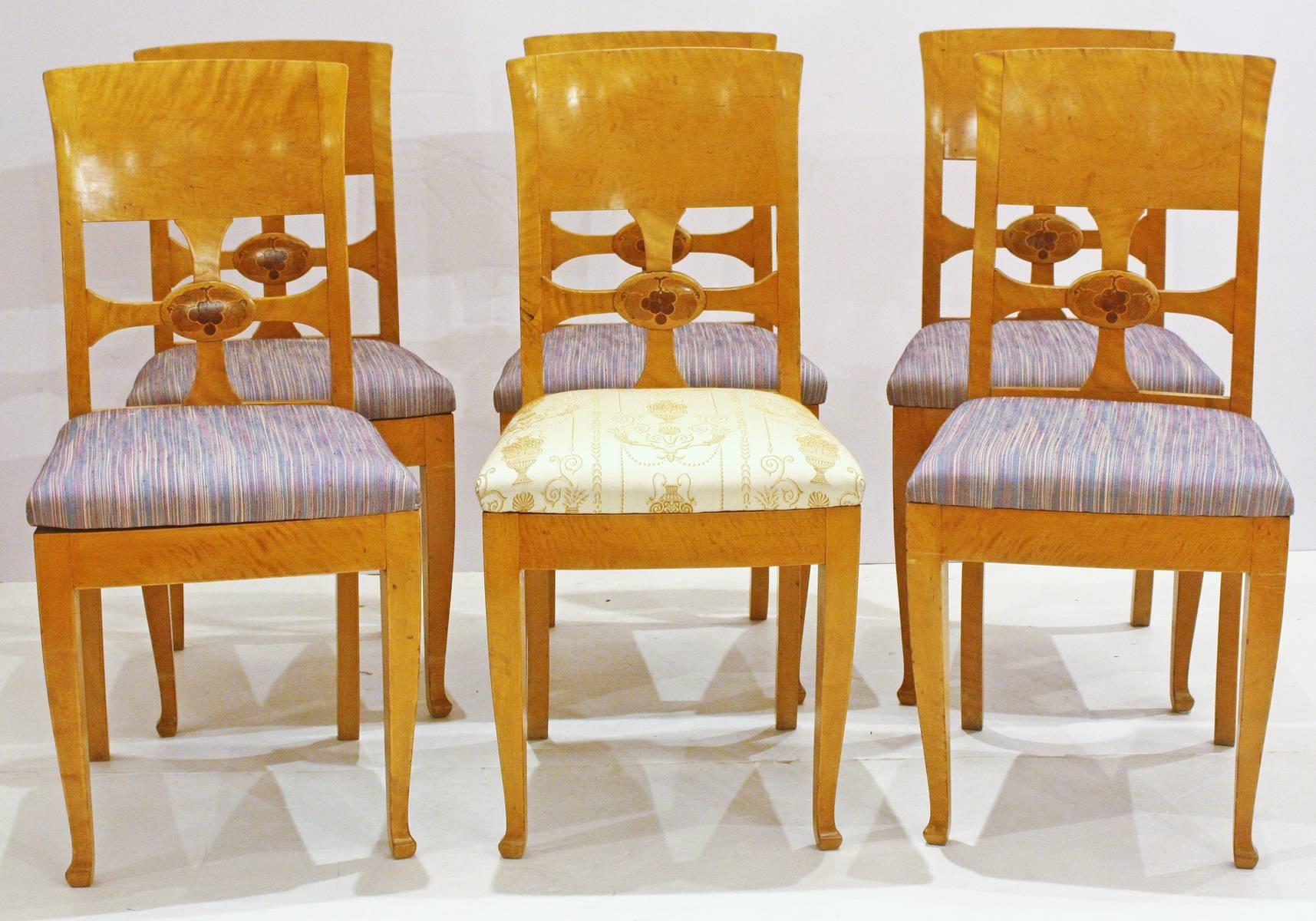 Chairs by cabinetmaker Anton Kjaer, Copenhagen, Denmark, a set of six birch chairs with panel backs, open cross with inlaid grapes and leaves in circle, metal tag from maker.