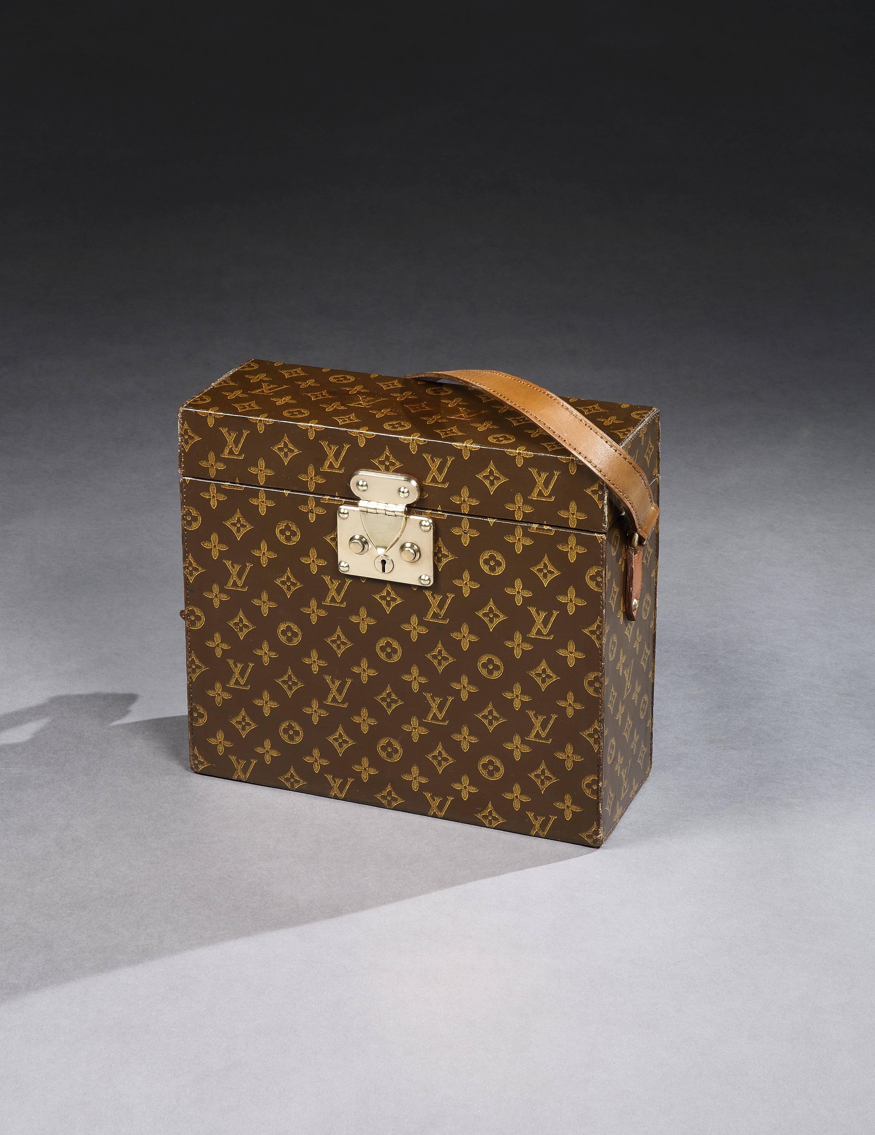 A rare special-order Louis Vuitton wine bottle carrier in the Classic LV ‘Monogramme’ pattern canvas, the hinged lid lifting open to reveal dividers for holding three wine bottles, and a special spring-loaded compartment perfect for a ‘waiter’s