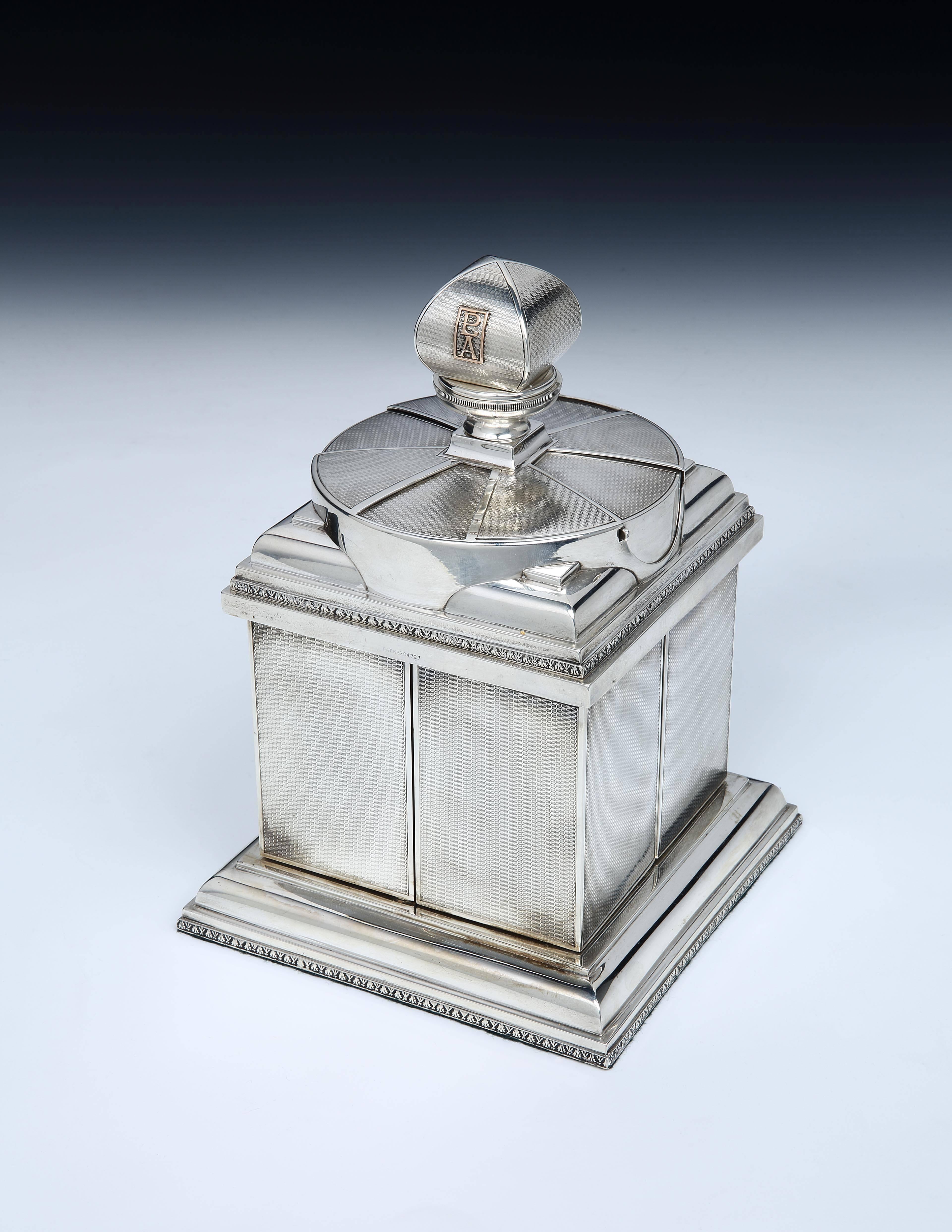 A rare, sterling silver ‘swivelling’ cigarette box by Asprey & Co., with an engine-turned body and large finial with applied monogram ‘PLA’ in gold, the top section with rotating covers where the (original) vesta matches are stored, along with the
