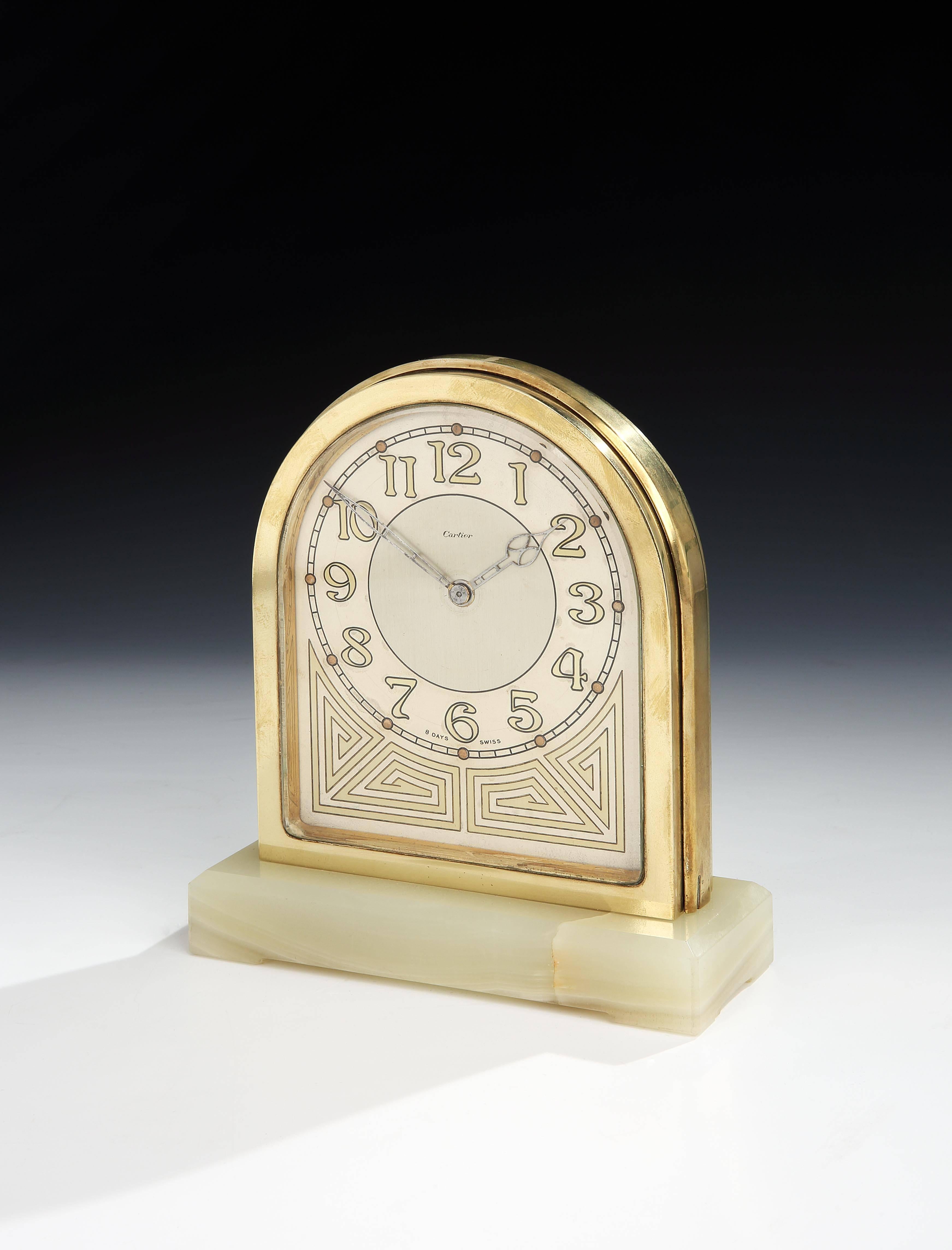 A highly unusual ‘partners’ clock, the arched body in gilded bronze, with clock face to both sides for ‘partners’ sitting opposite each other, both clock faces with identical Art Nouveau numerals and gilt detailing with delicate pierced hands.