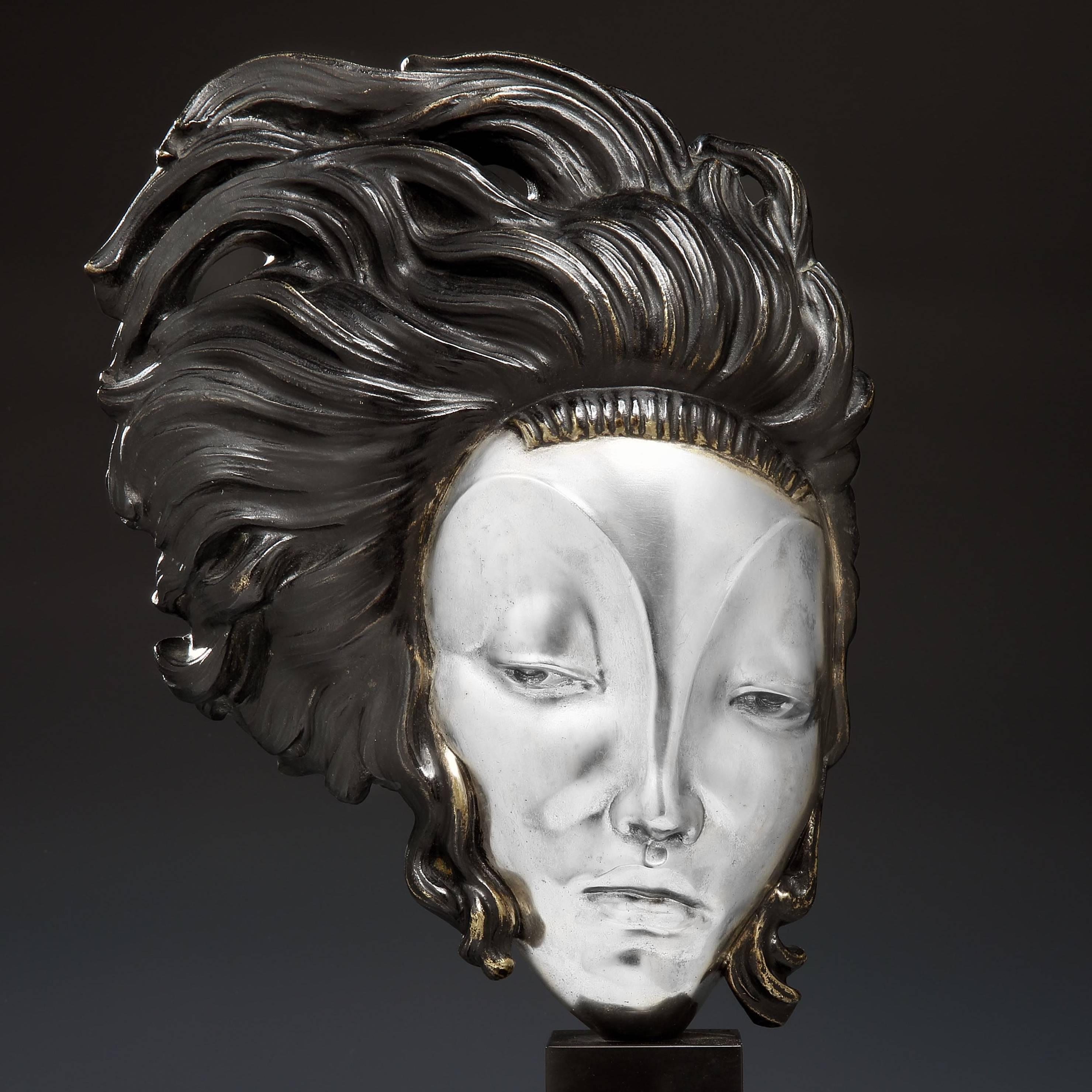 An Art Deco bust in silvered and patinated bronze, entitled 'Medusa Moderne' cast, circa 1925. 

The female face with delicate features is framed by tendrils of textured, dark-patinated hair, with areas of bronze highlights. The bust is mounted on