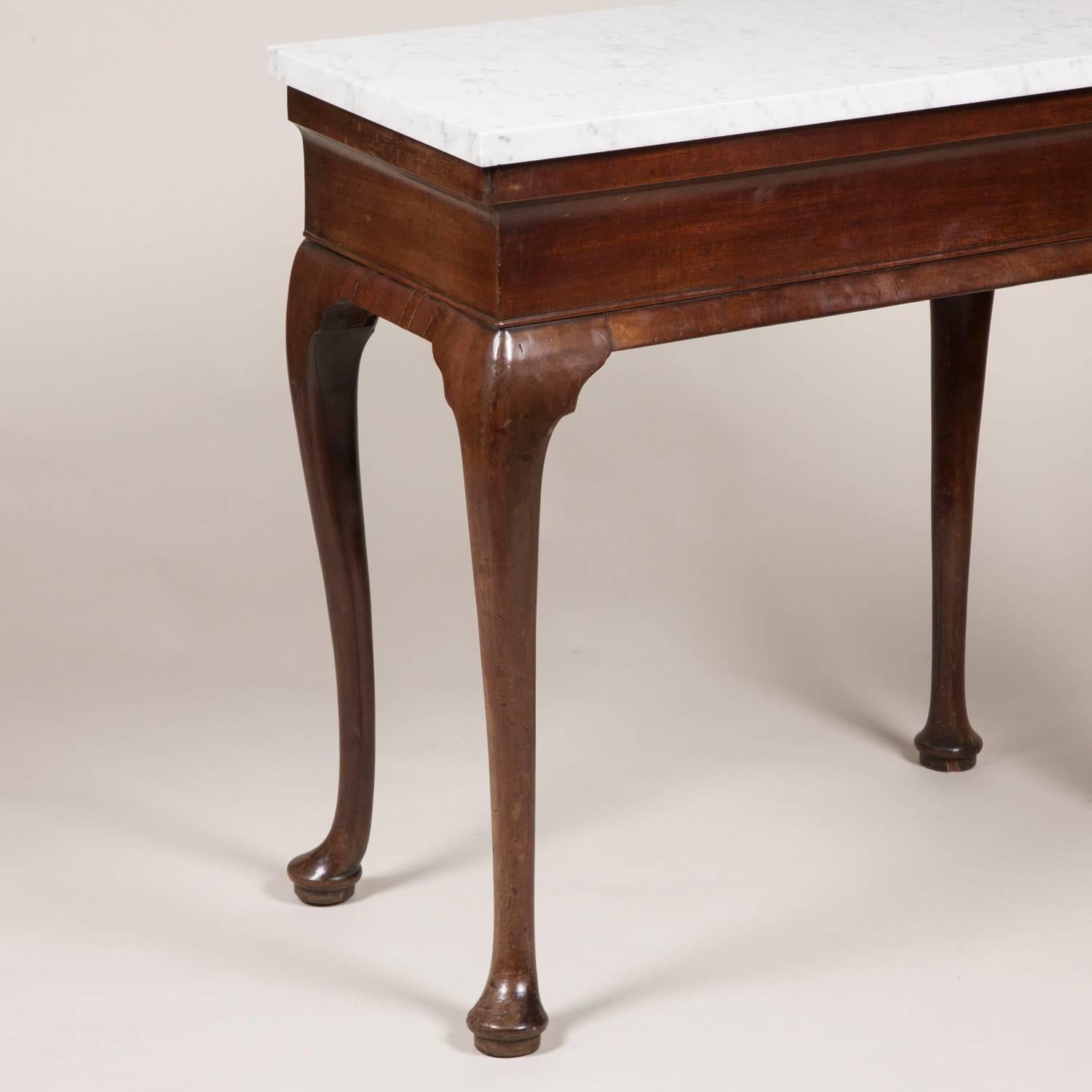 An unusual George II mahogany side table, circa 1750 with tapering veined Carrara marble top and cabriole legs.