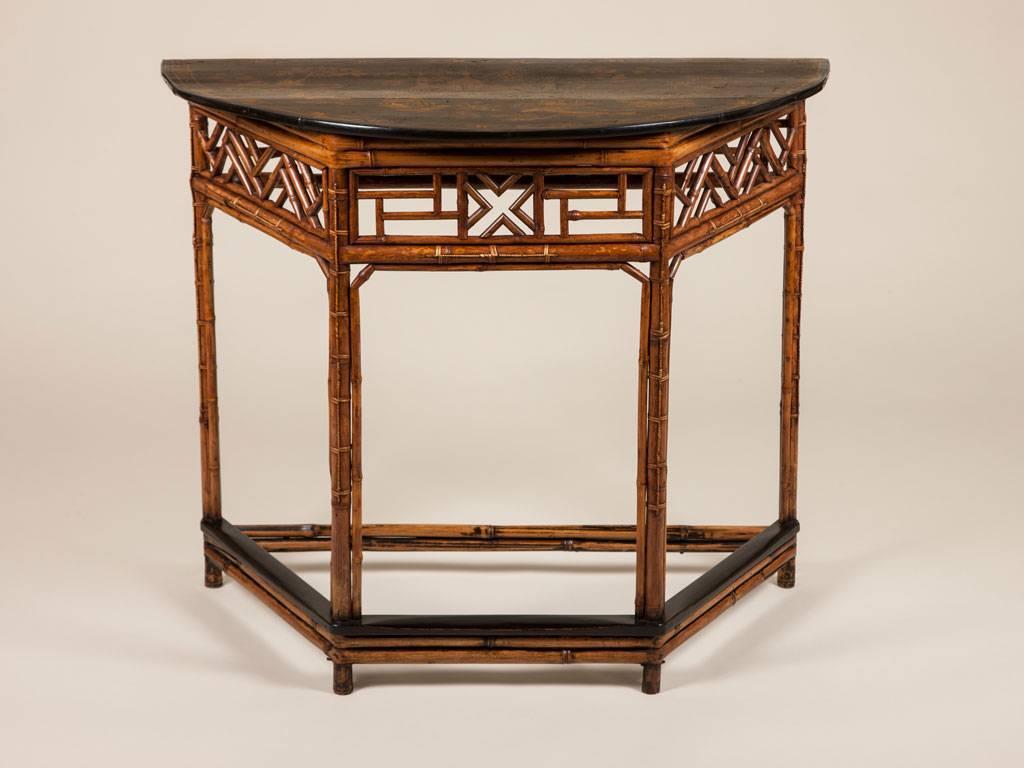 A bamboo side table with a demilune Chinoiserie decorated top, circa
1880