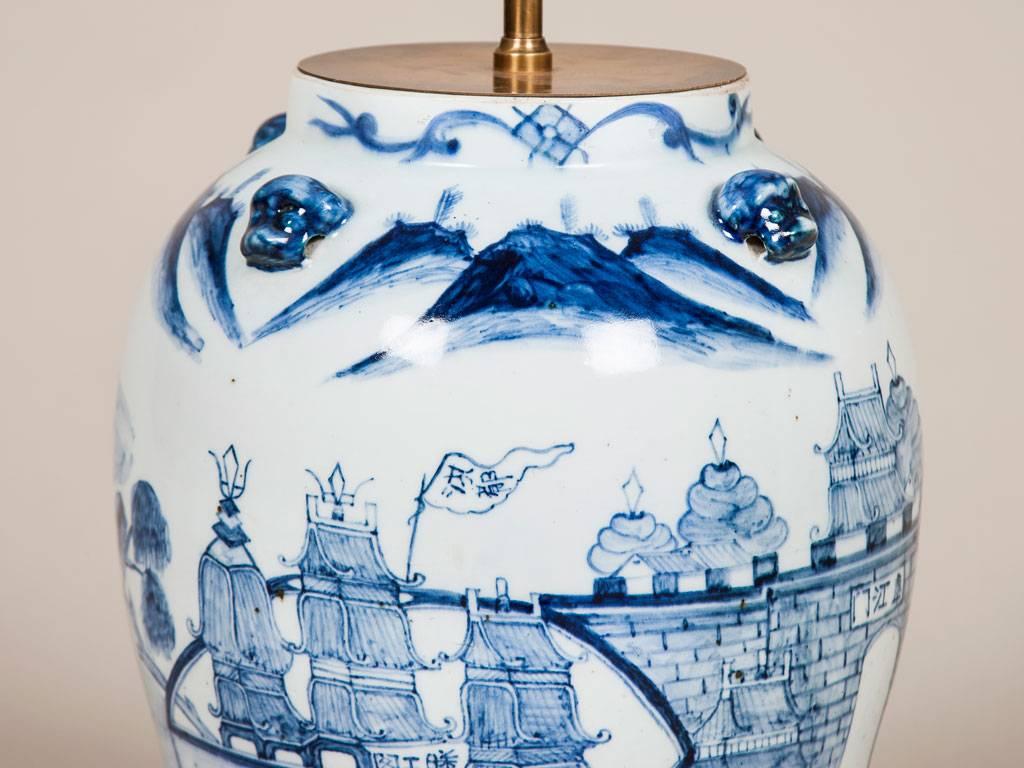 An 18th century Chinese blue and white pottery vase with lions mask handles, wired as a lamp.