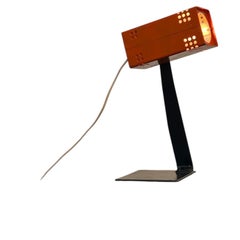 Vintage Bauhaus-style industrial orange desk lamp, with black foot.