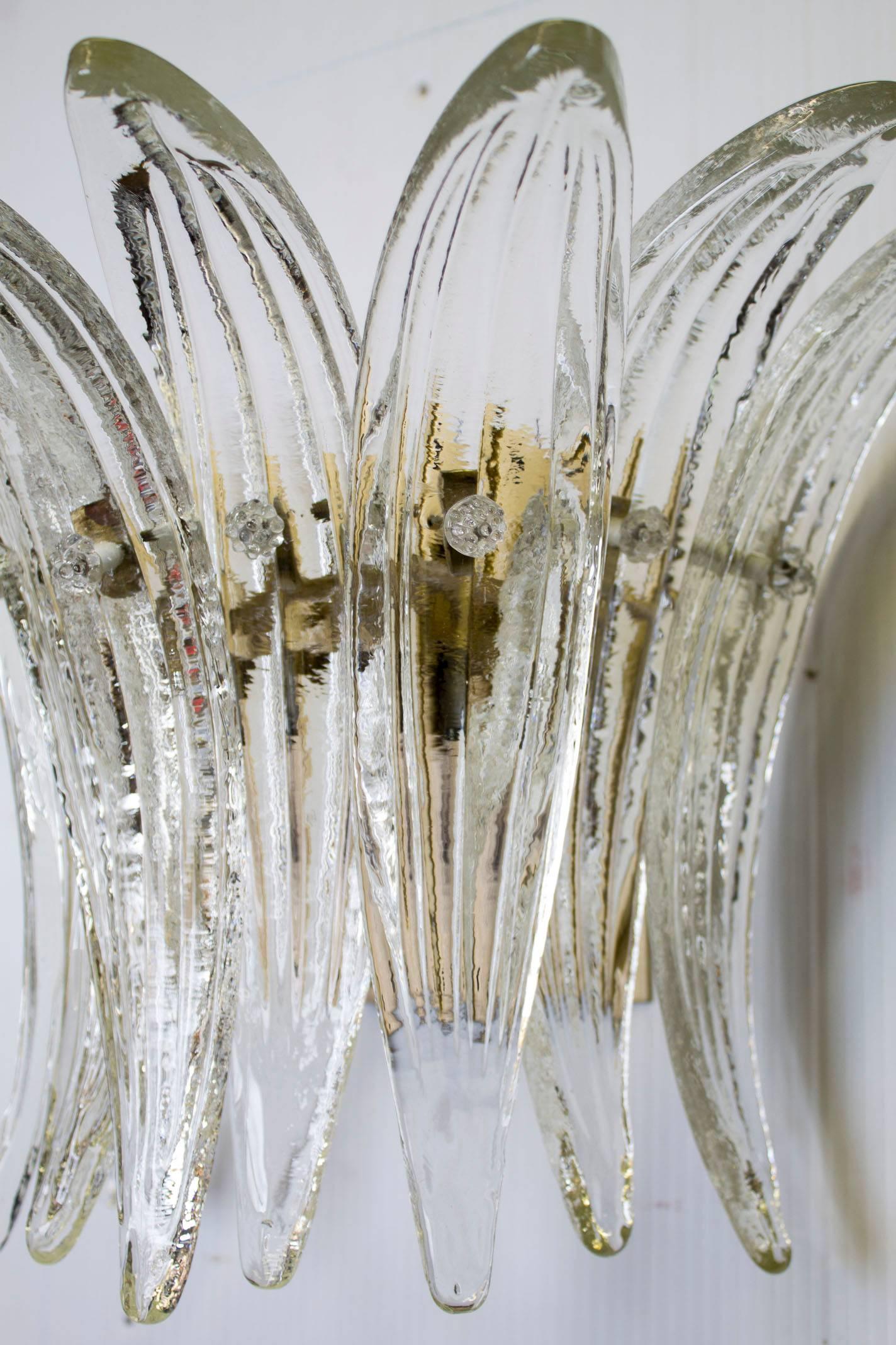 A pair of clear molded Murano glass feather sconces.
