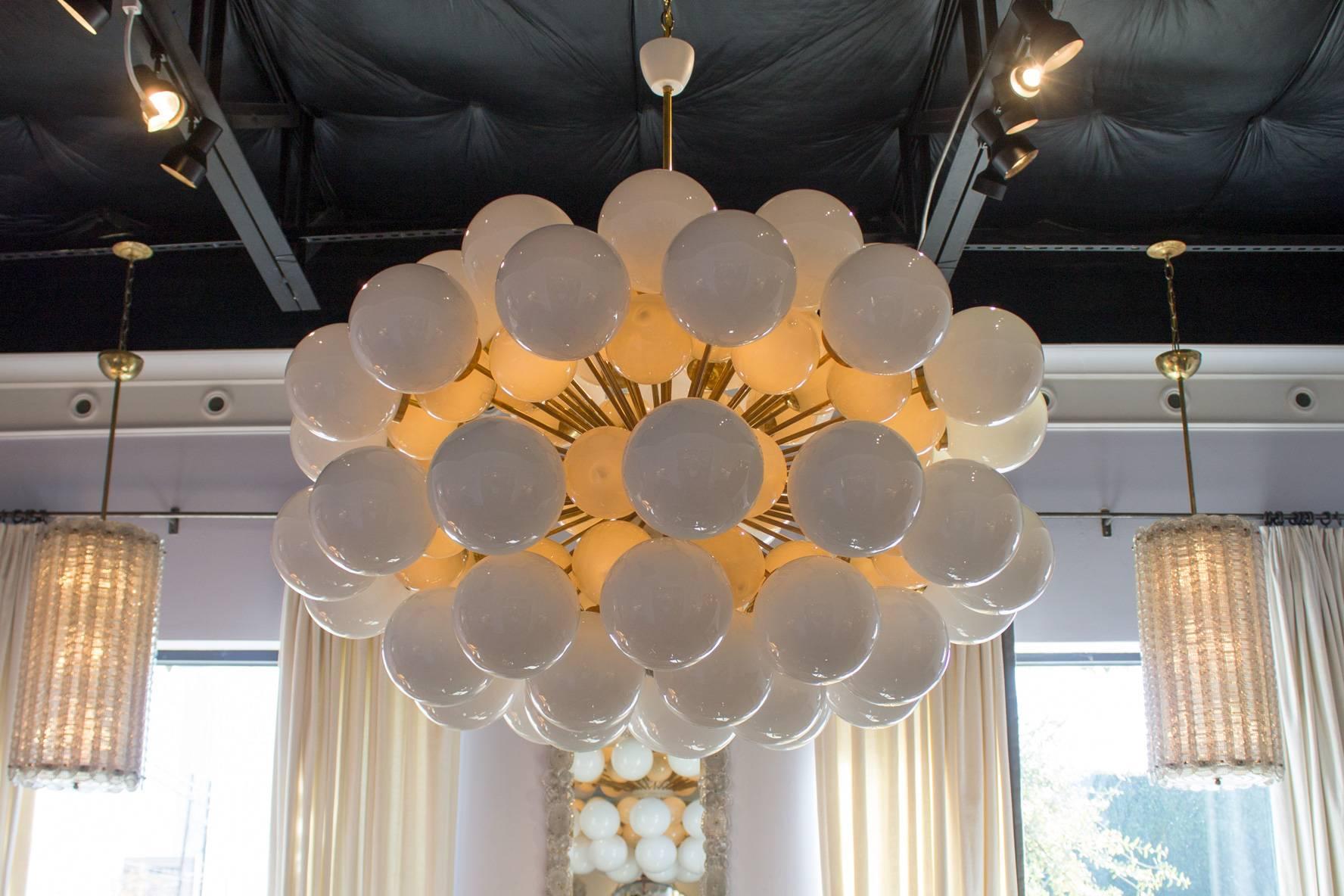 This chandelier in the style of Stilnovo features 114 white & grey handblown glass spheres - mounted on an elaborate brass frame.
