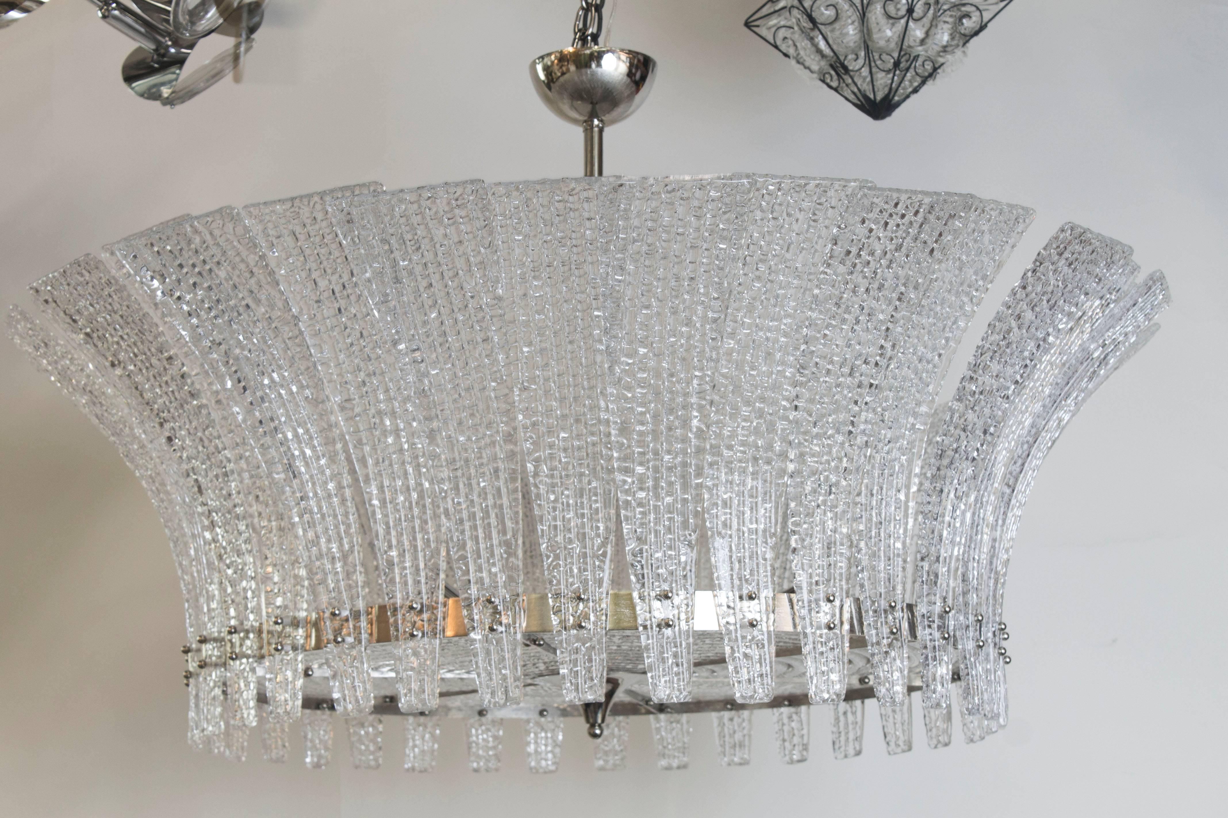 A gorgeous Italian drum chandelier in clear molded Murano glass with a nickel frame and fittings.