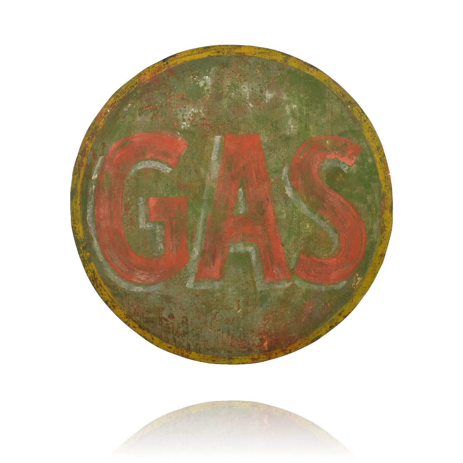 This is a large round GAS sign that was made of wood and is all hand-painted. It has the appearance of an old weathered sign from a gas station, but was more likely made for a TV or movie set as a prop. Extremely well done, this piece would be right
