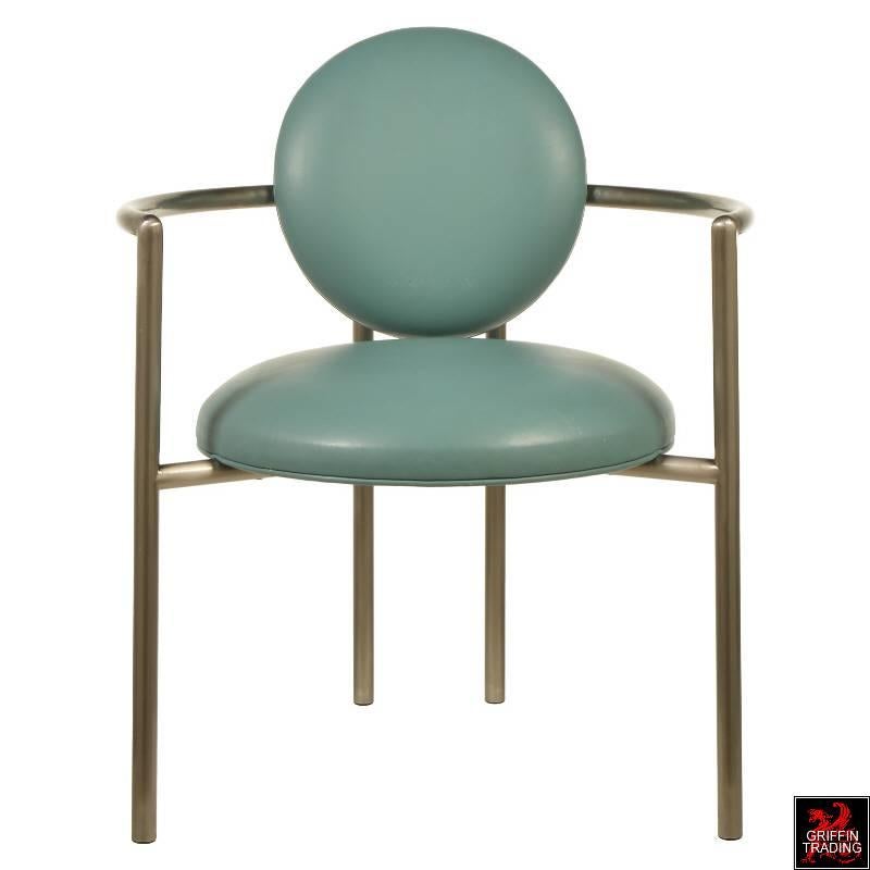 This fabulous set of eight dining chairs are called “Moon Chairs.” These comfortable and wide armchairs were designed by American designer Stanley Jay Friedman and manufactured by Brueton. Their distinctive design and brushed metal tubular frames