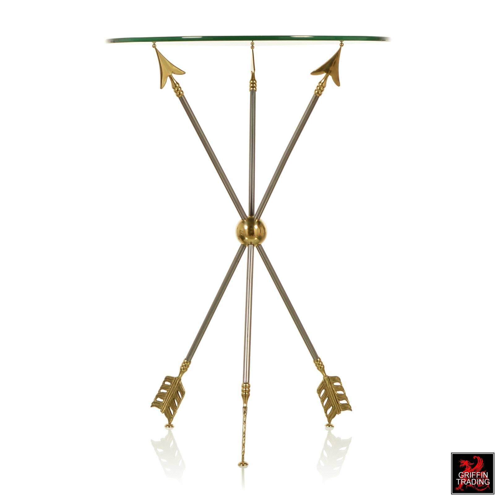 Lovely neoclassical style gueridon by Maison Jansen. This striking side table has a beveled glass top with distinctive tripod base made of steel arrows with brass arrowheads and feathers. The perfect accent table for that Hollywood Regency