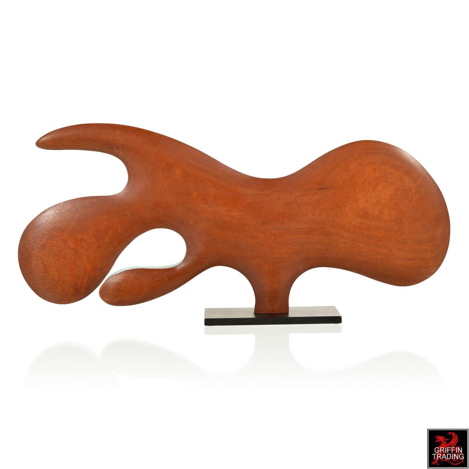 This abstract wood sculpture is affectionately named “The Swimmer” and is the work of artist David Robin Hoyt. The richly grained mahogany wood form with its turquoise blue edge has a distinctly Mid-Century Modern feel. Like other works by this