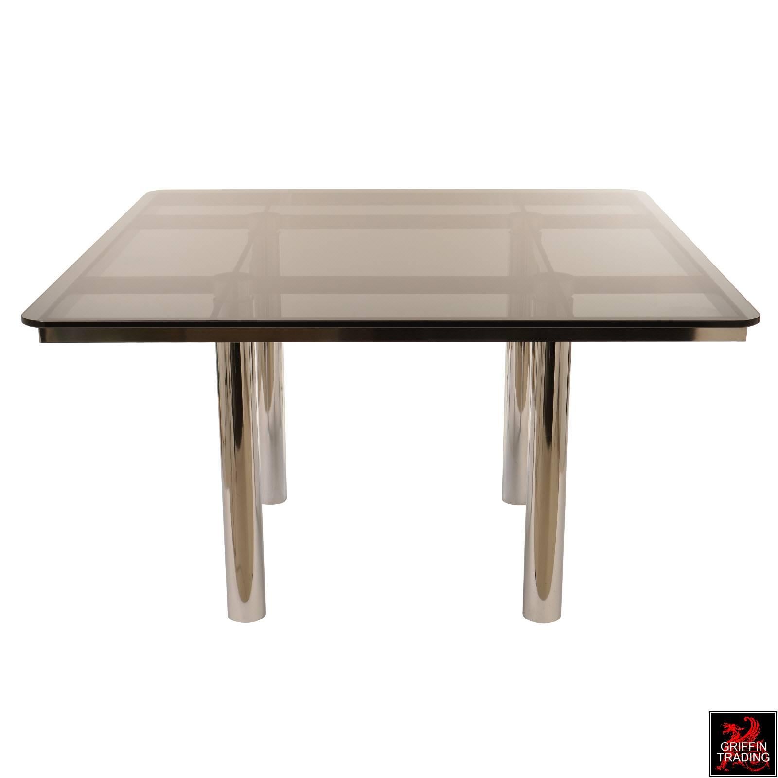 This architectural style dining table with its bold grid pattern made of chrome steel is called Andre. The Andre dining table was created by the Italian designer Tobia Scarpa in 1967 and was produced by Gavina in Italy. Gavina was purchased in 1968