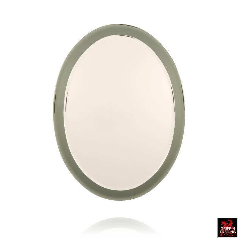 This elegant Italian oval wall mirror with mirror frame is in the style of Fontana Arte. The oval shaped central glass mirror has a 1/2? beveled edge and is floated over a larger darker colored mirror that has a 5/8? beveled edge. The larger mirror