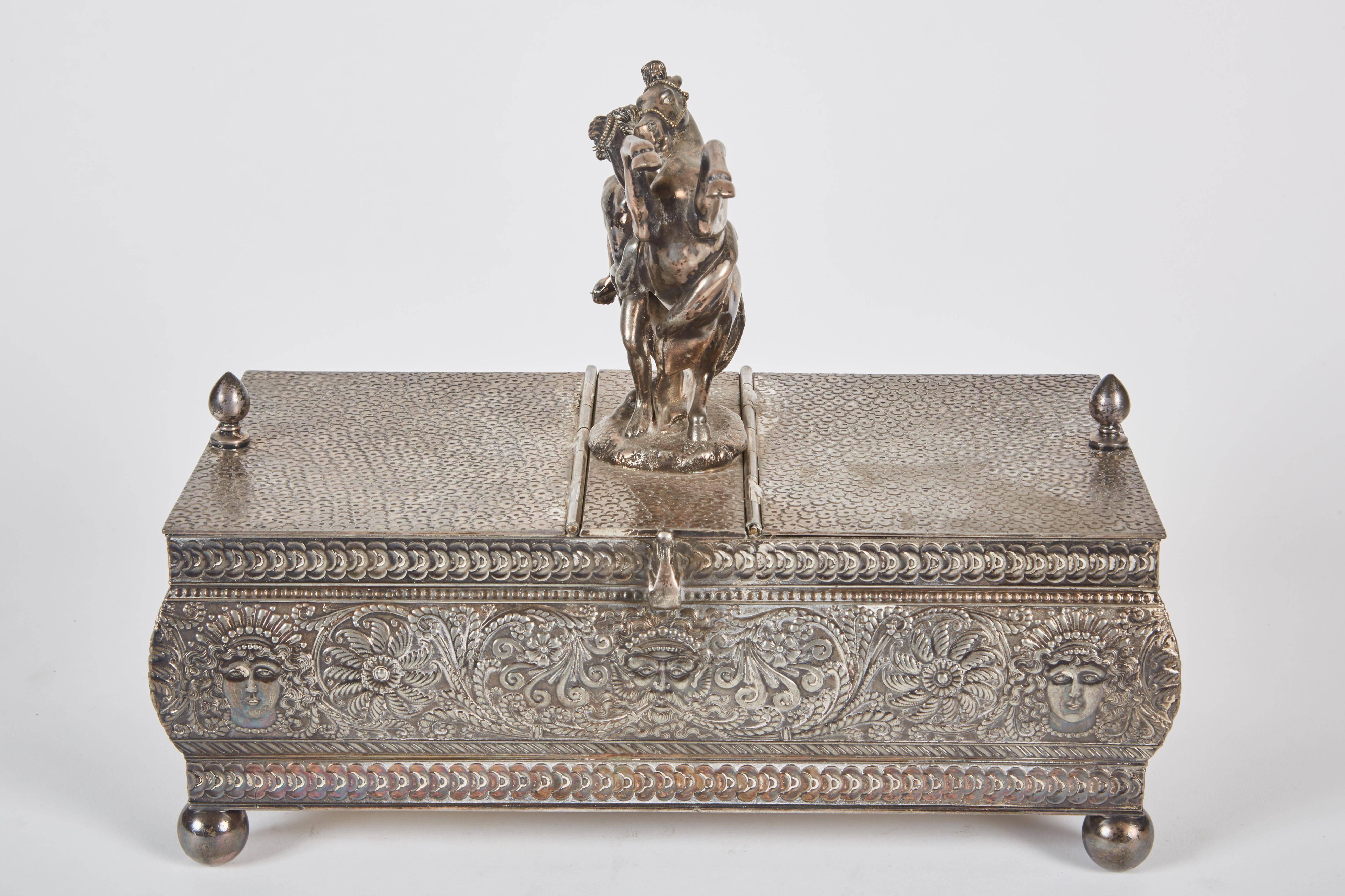 A fine 19th century Italian silver plated humidor with etched foliage motifs throughout the humidor with a warrior and horse figures. There are two cigar compartments on either side of the figurine.