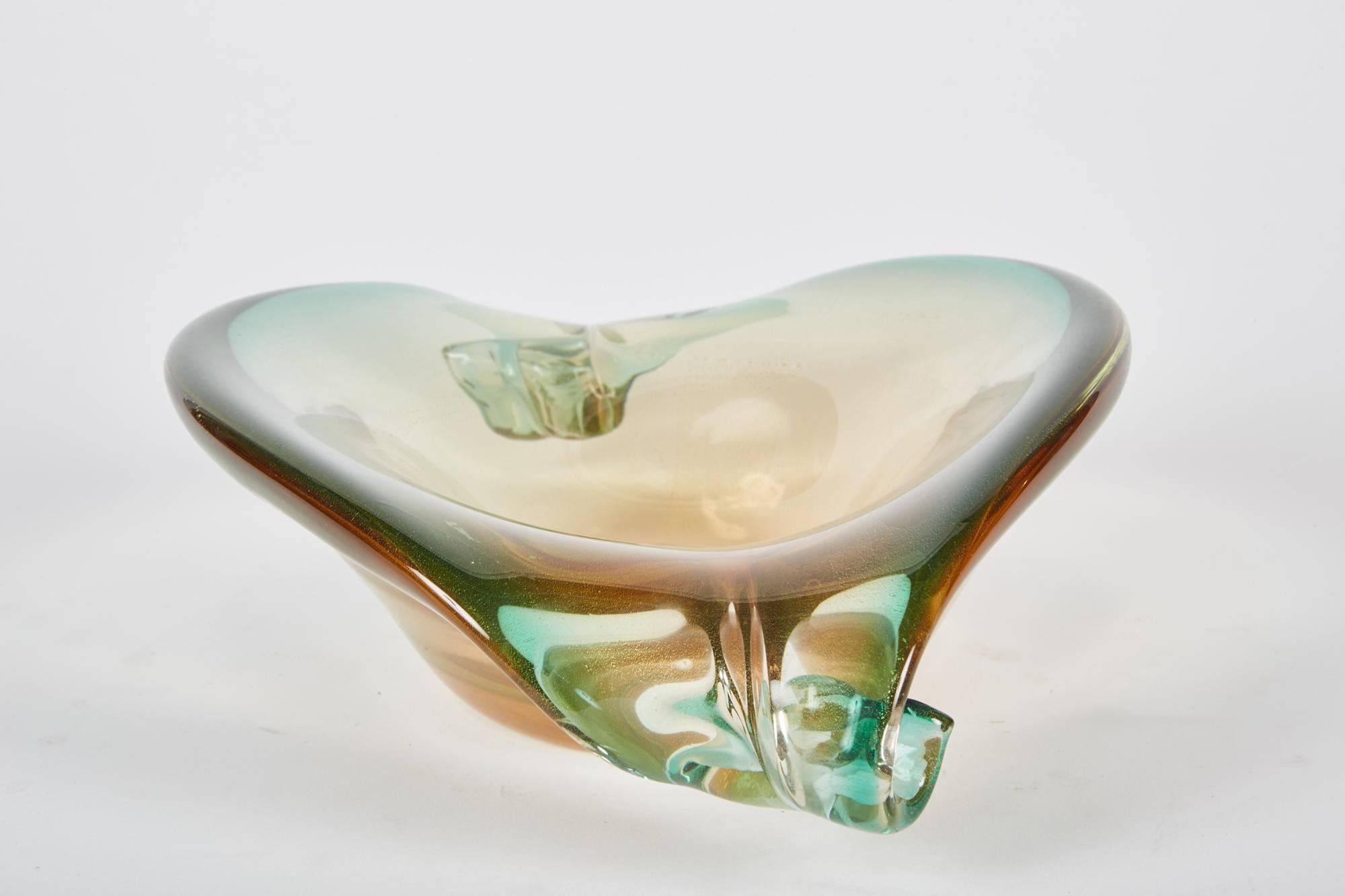This vintage Murano glass centerpiece has two scrolls on either side of it with a beautiful gradient of green and gold.