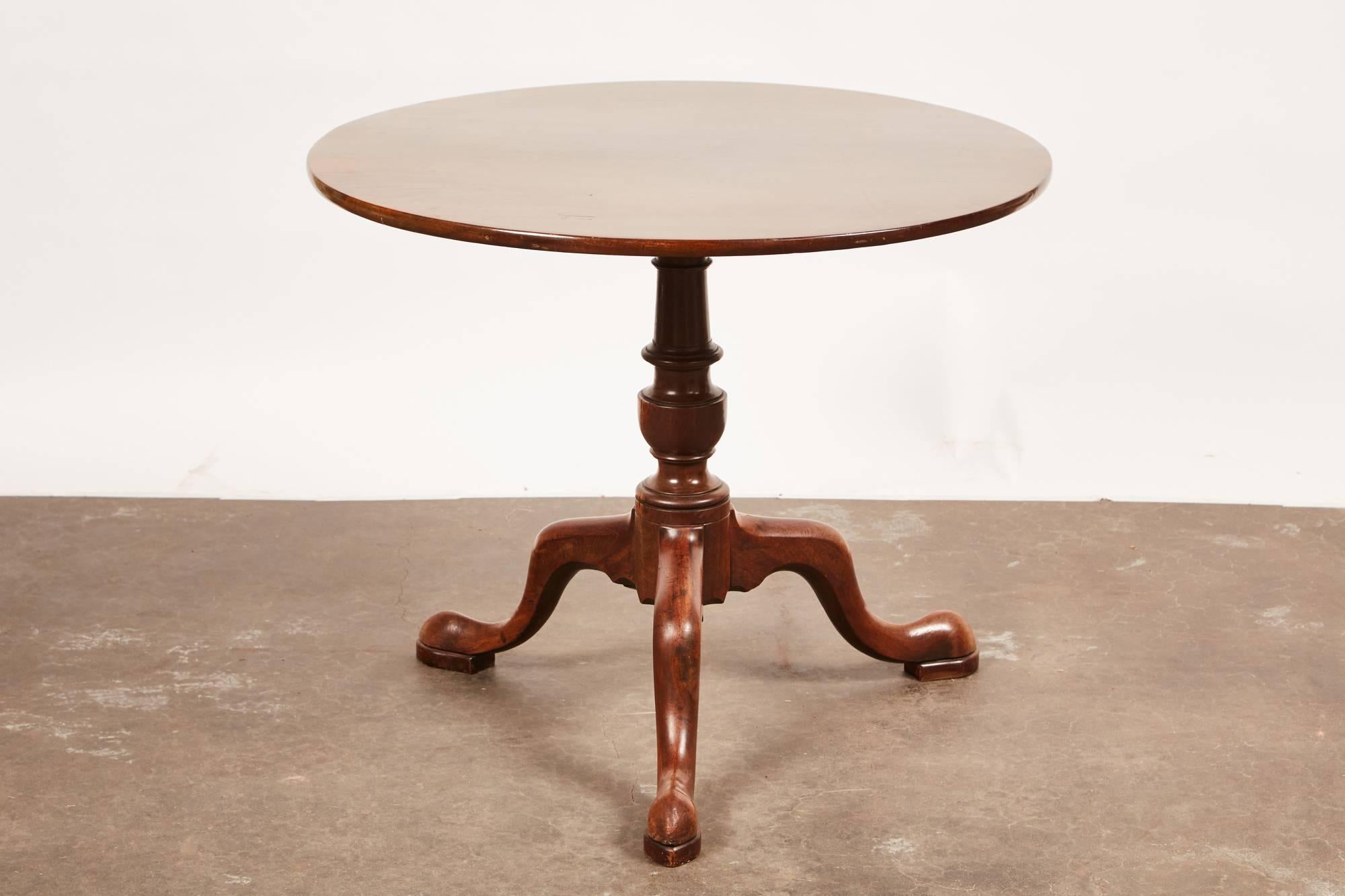 A 19th century English Queen Anne mahogany pedestal table on a tripod base.