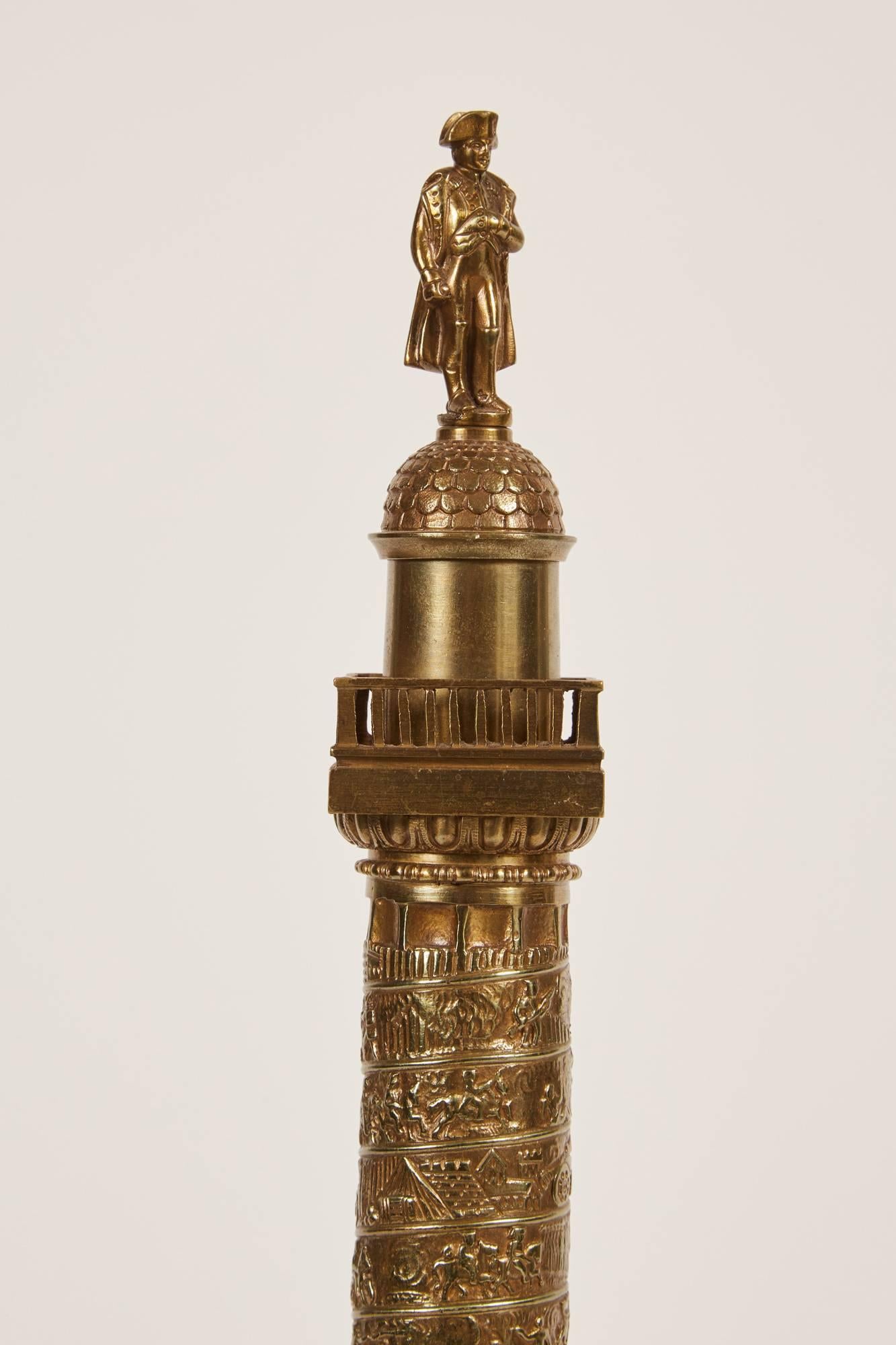 This 19th century bronze model is representing the Colonne De La Grande Armée found in Wimille, France. It was constructed to be a column honouring the soldiers of the Grande Armée and features a spiral frieze that recounts the Campaign, from the