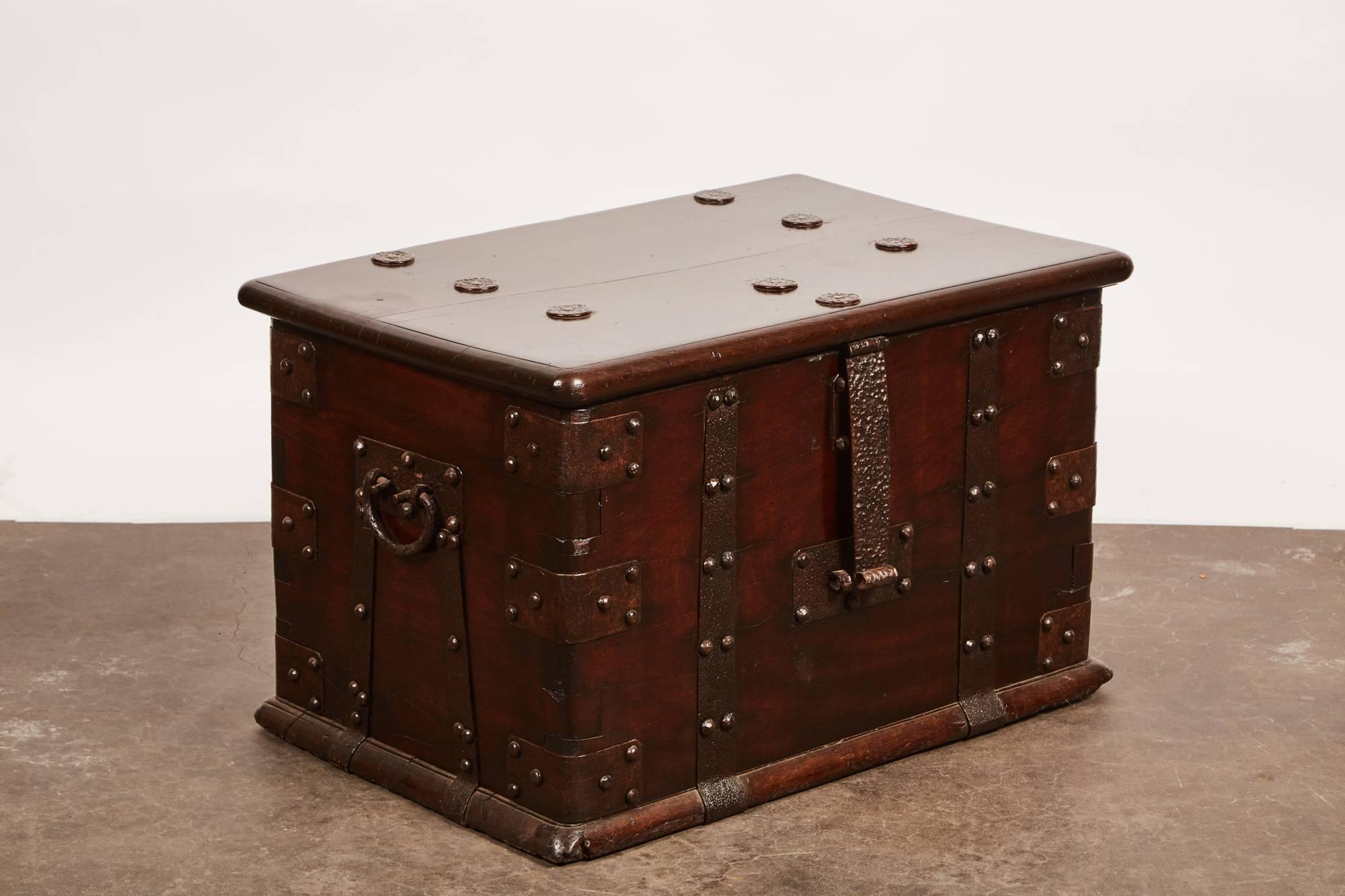 A late 18th century Chinese iron bound money safe from Guangdong, China. The piece features simple and exquisite metal work, nailheads, and comes with a key made from iron wood. Within the money safe there is one shelf on the right side of the chest.