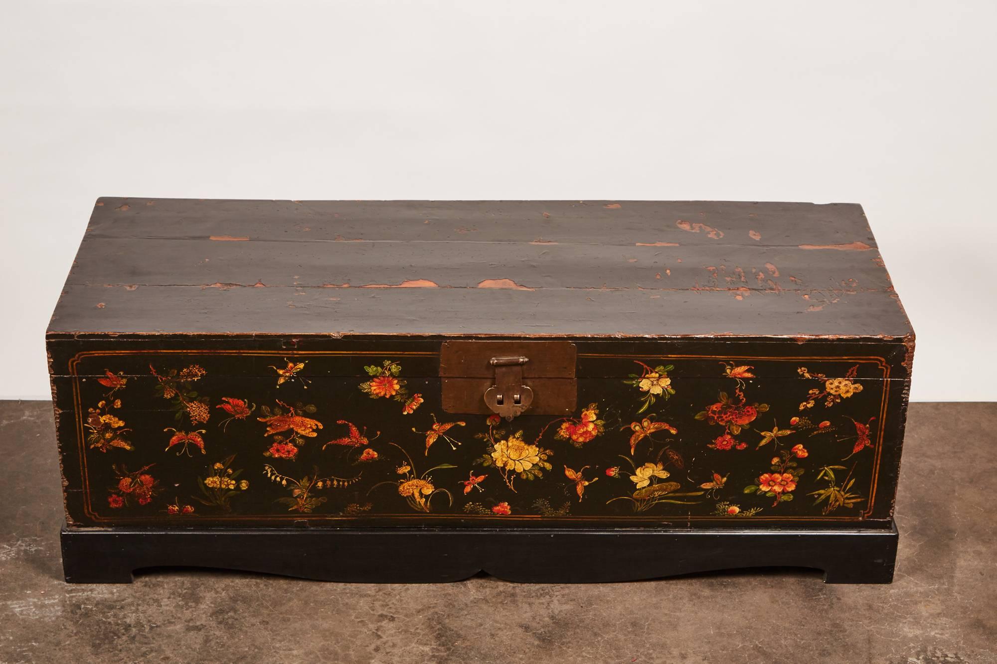 This 19th century lacquer painted Chinese trunk is designed with stunning butterfly motifs along the facade. The lengthy trunk does not only feature the butterfly motif, meant to represent happiness, but also includes a variety of flower types. This