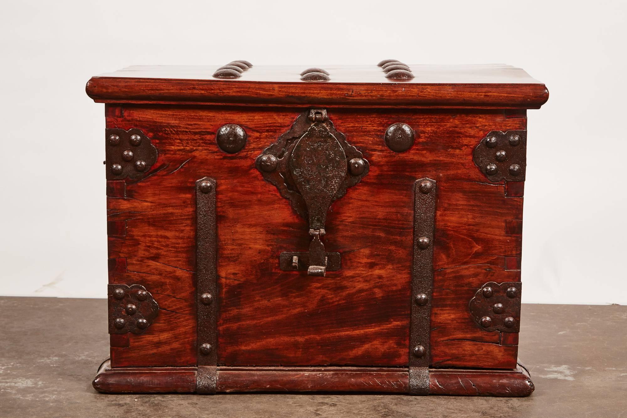 This 19th century Qing dynasty iron bound chest features nailheads and other metalwork throughout the exterior of the chest. Its intricate metal work and design allows the piece to be distinctive to the this Chinese style. Within the box, there is a