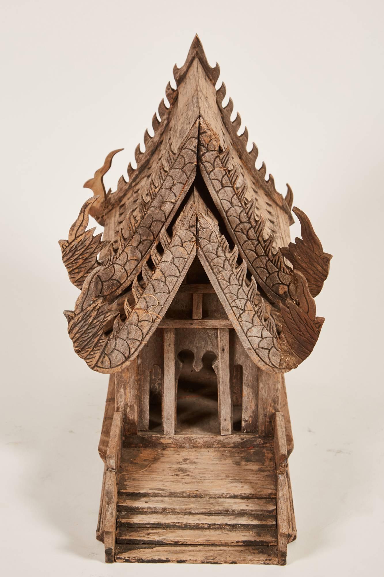 An early 20th century replica of the Buddhist temple Vihara in Thailand. A spirit house is made in order to protect the building it represents from any bad in the world. “A Buddhist ceremony takes place to invite a protective spirit to inhabit the