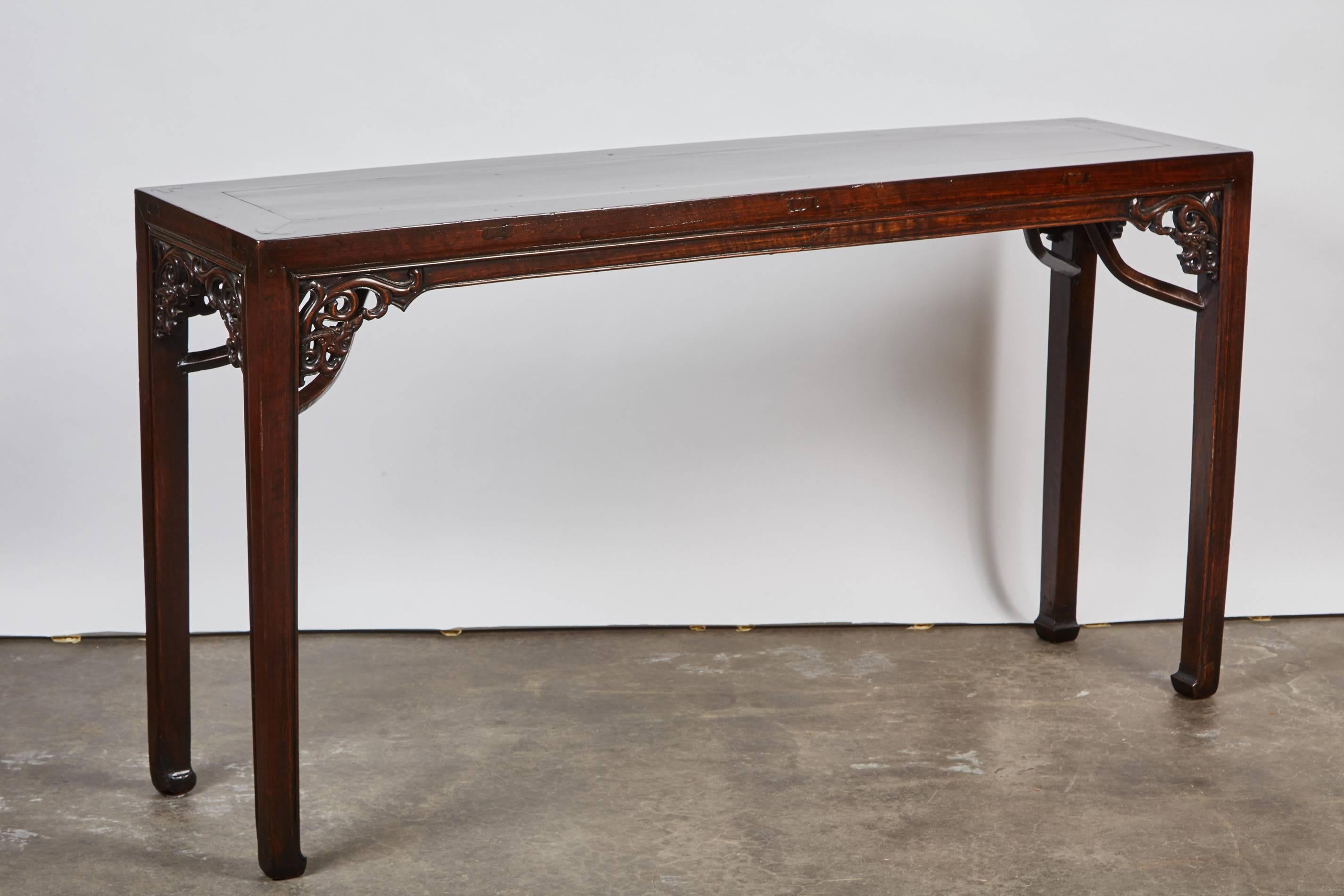 Rare 18th century Qing dynasty small walnut altar table with under braces and refined carving from Shanxi, China.
