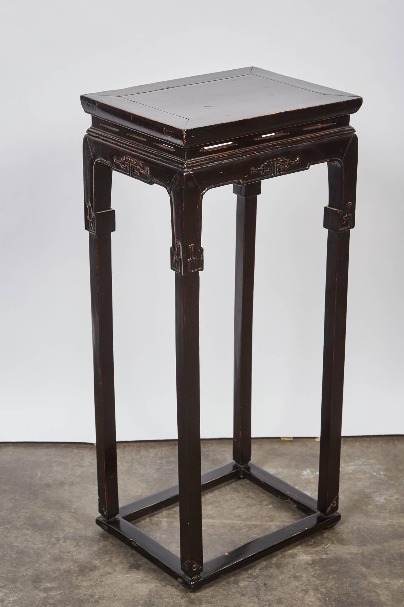 Pair of 18th century Chinese rectangular hardwood tall think black lacquer tea tables with beautiful hand-carved details in the panels and on the foot of the legs. These twin tea tables are originally from Shanxi, China.