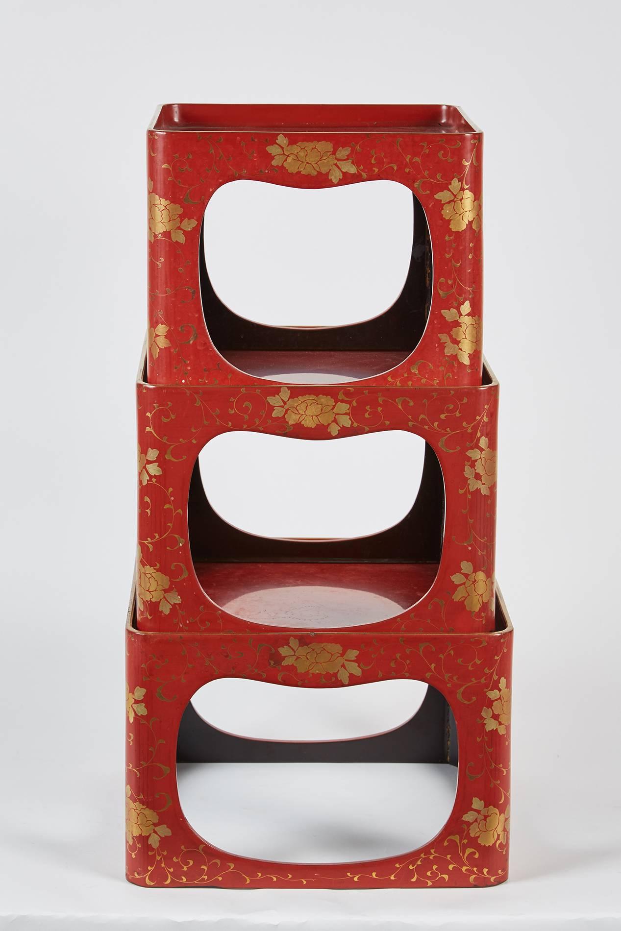 A lovely set of lightweight Japanese lacquer stack trays that feature painted vines and flowers throughout.