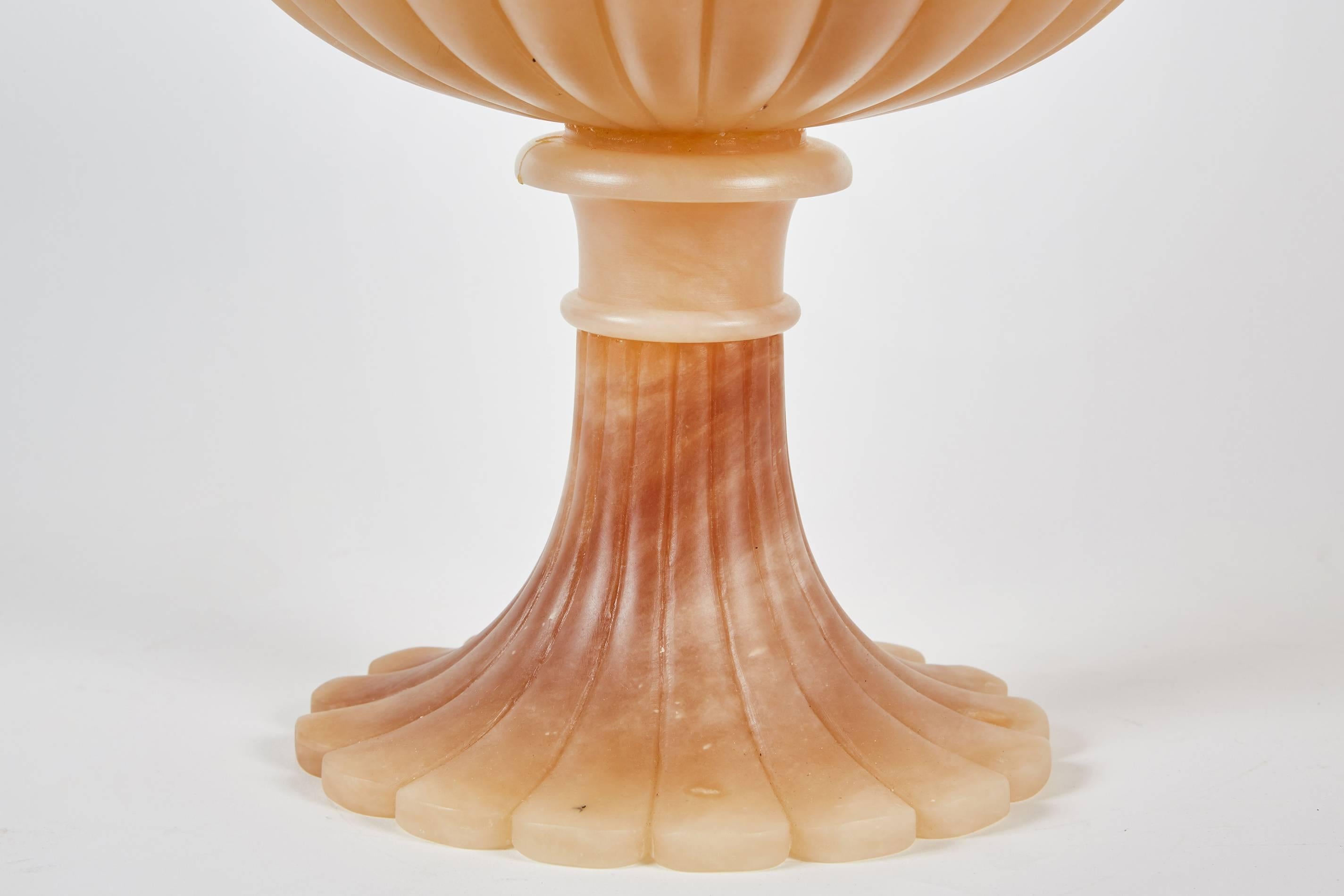 A lovely Italian alabaster bowl sitting on a footed pedestal.