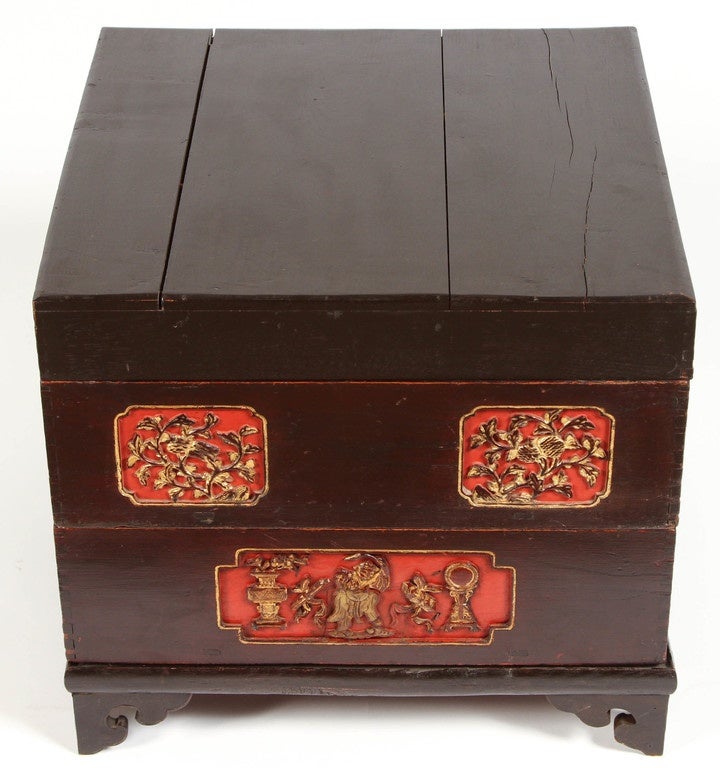 A 19th Century Chinese lacquer stacking cake box with carvings painted in gold and red.  This was a lacquer box for presentation when someone was engaged and the couple was presented with pastries or cakes.