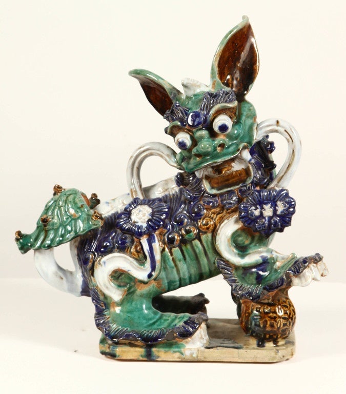 An elaborate pair of late 19th century Chinese porcelain dogs. Known as Shi in China and commonly referred to in the West as Foo dogs, these porcelains represent guardian lions that conveyed powerful mythic protective benefits. These Chinese Foo
