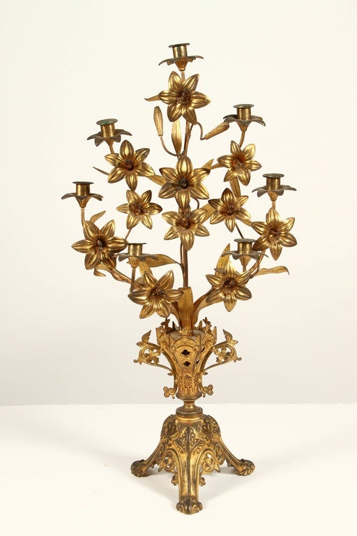 A pair of French Thanksgiving candlesticks; the term is used for donations to a church. I9th Century gilded metal, in the form of branches of flowers, seven candle holders in total. These French candlesticks are elaborately shaped and decorated in