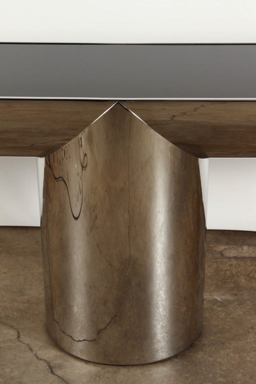 A late 20th Century console table in stainless steel, by J. Wade Beam for Brueton, circa 1970. The Tee Console table is characterized by a deliberate sculptural interplay of cylindrical forms. The simple design of the pedestal base continues to