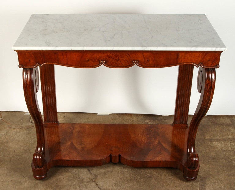 19th century Northern Italian Console with solid curved front supports, veneered in figured mahogany, with the original white marble top.