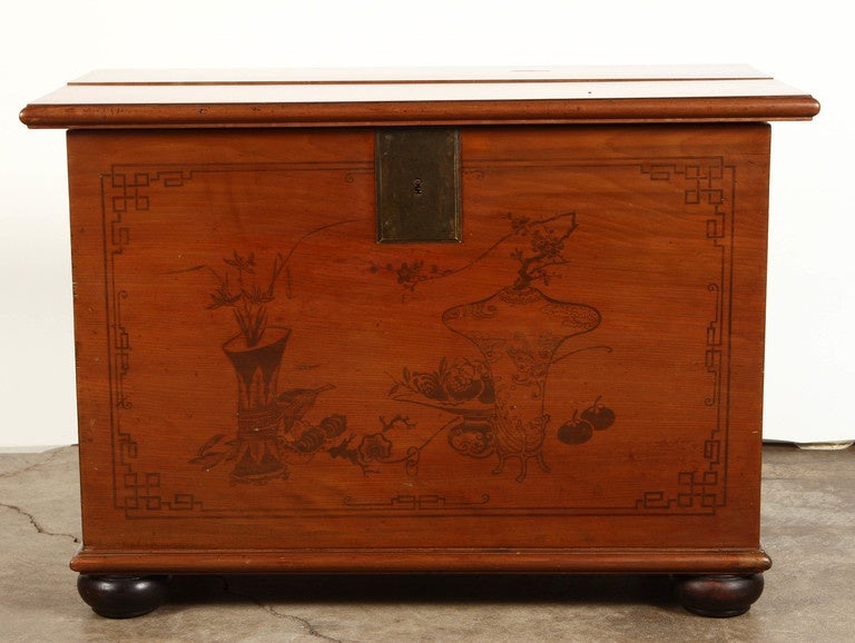 A late 19th century Chinese trunk from Taiwan painted with ink paintings and made of special Mycelia wood that accepts the ink evenly. The top lifts from the trunk and reveals two otherwise hidden drawers. In addition Bun feet have been added to